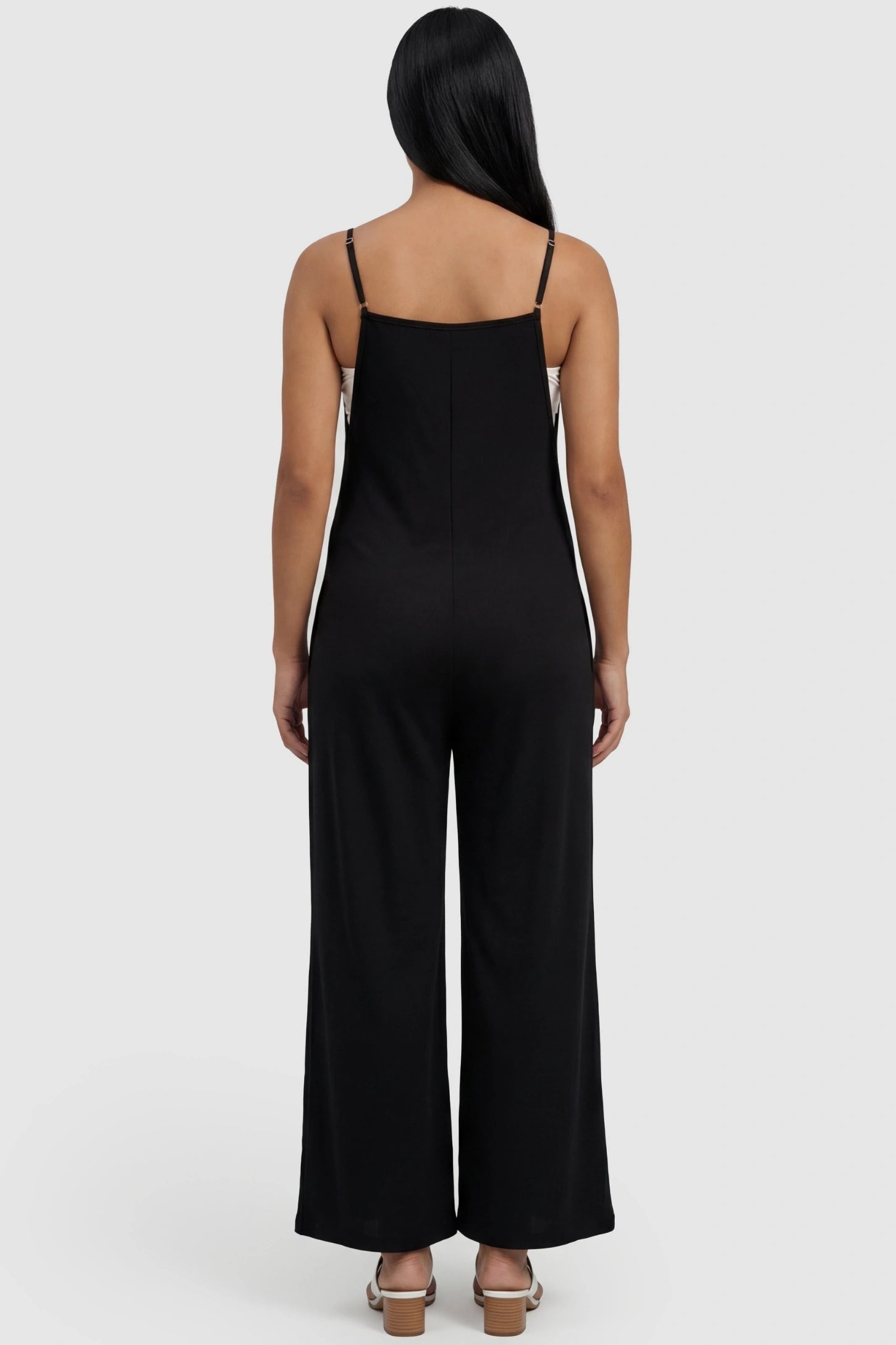 Square-Neck Zippered Wide-Leg Maternity Jumpsuit Square-Neck Zippered Wide-Leg Maternity Jumpsuit in Black featuring a adjustable straps on a pregnant model.