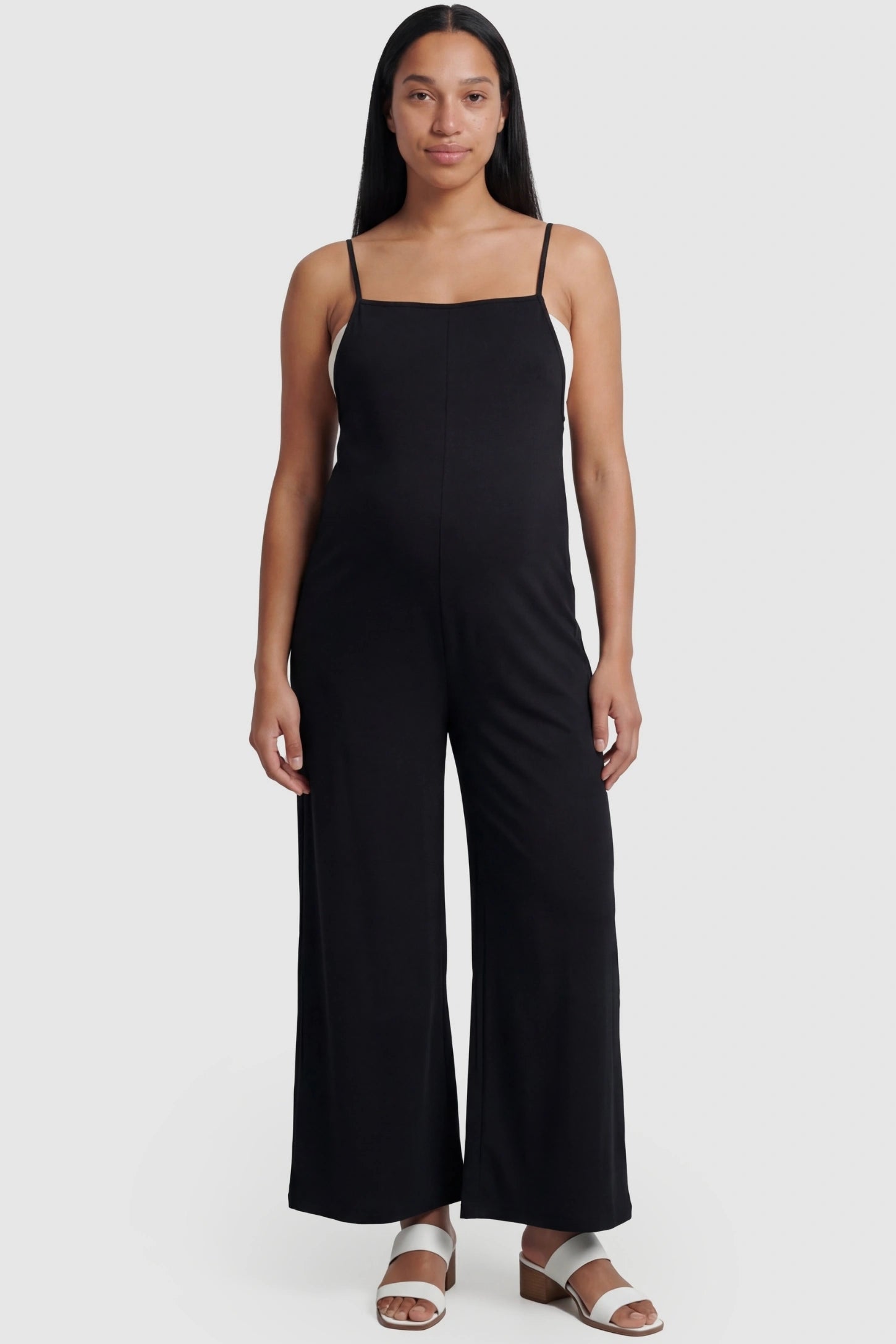 Square-Neck Zippered Wide-Leg Maternity Jumpsuit in Black featuring a sleek zippered back on a pregnant model.
