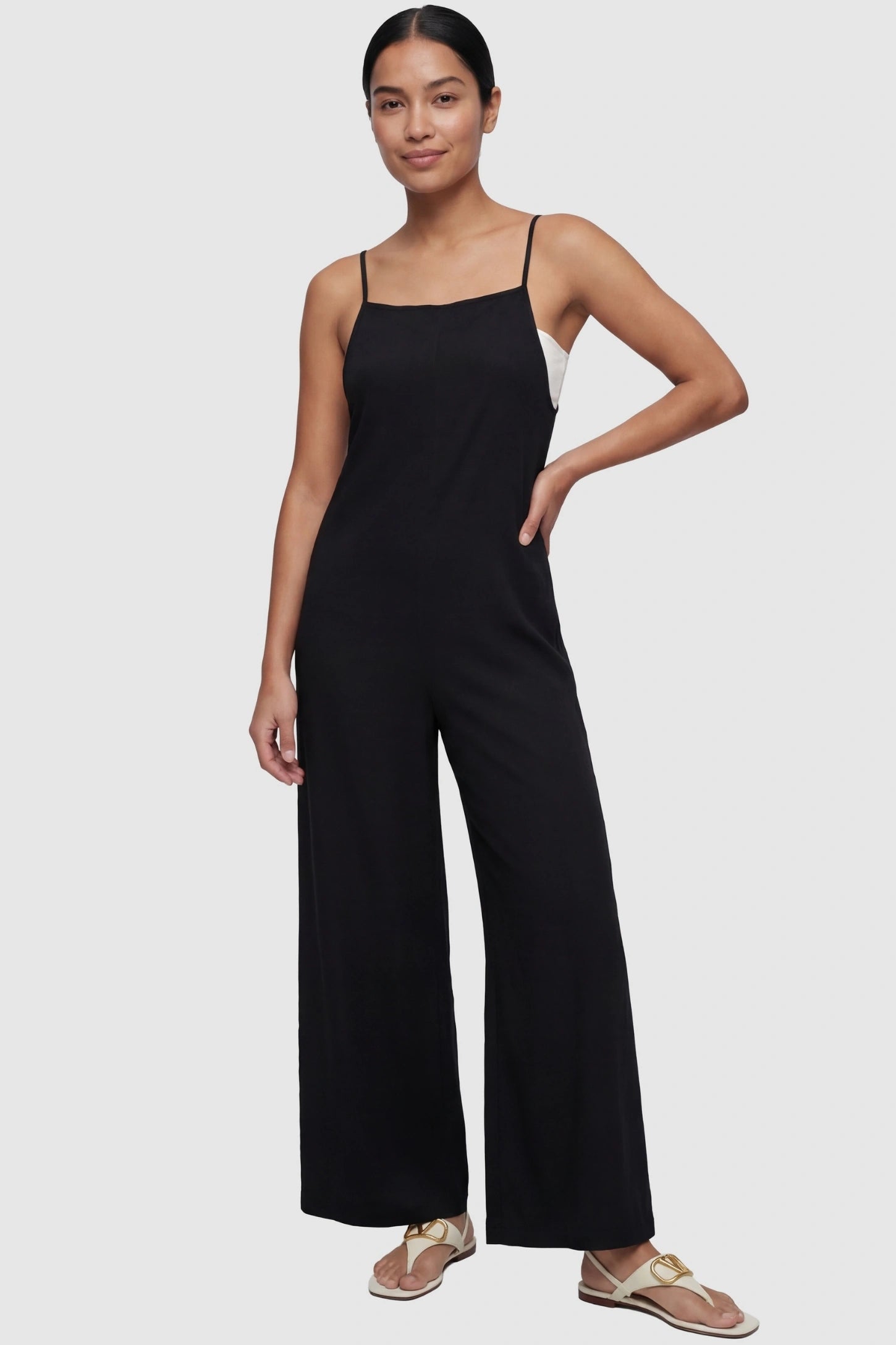 Square-Neck Zippered Wide-Leg Maternity Jumpsuit Square-Neck Zippered Wide-Leg Maternity Jumpsuit in Black featuring a sleek zippered back on a non-pregnant model.