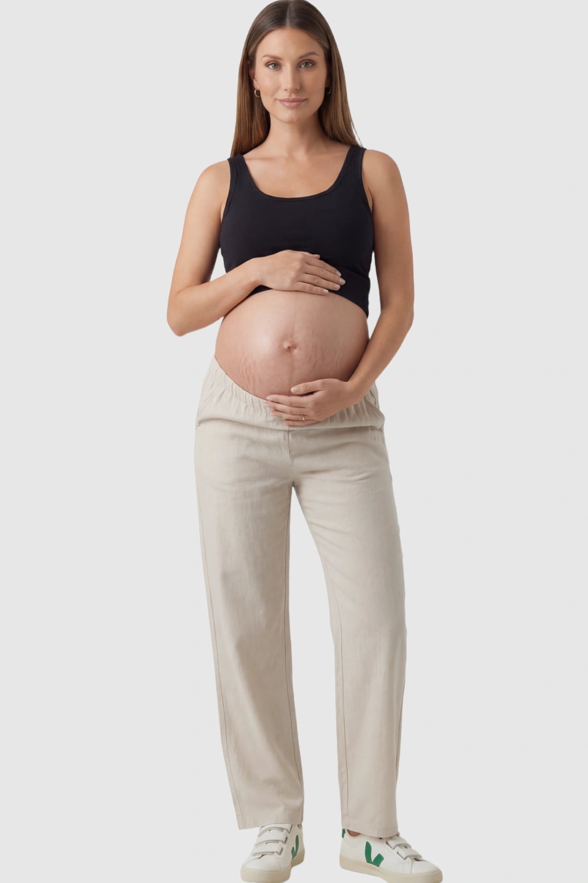 Adjustable Elastic Waist Wide Leg Maternity Pants Adjustable Elastic Waist Wide-Leg Maternity Pants in Beige featuring a customizable button-hole waistband on a pregnant model facing front.