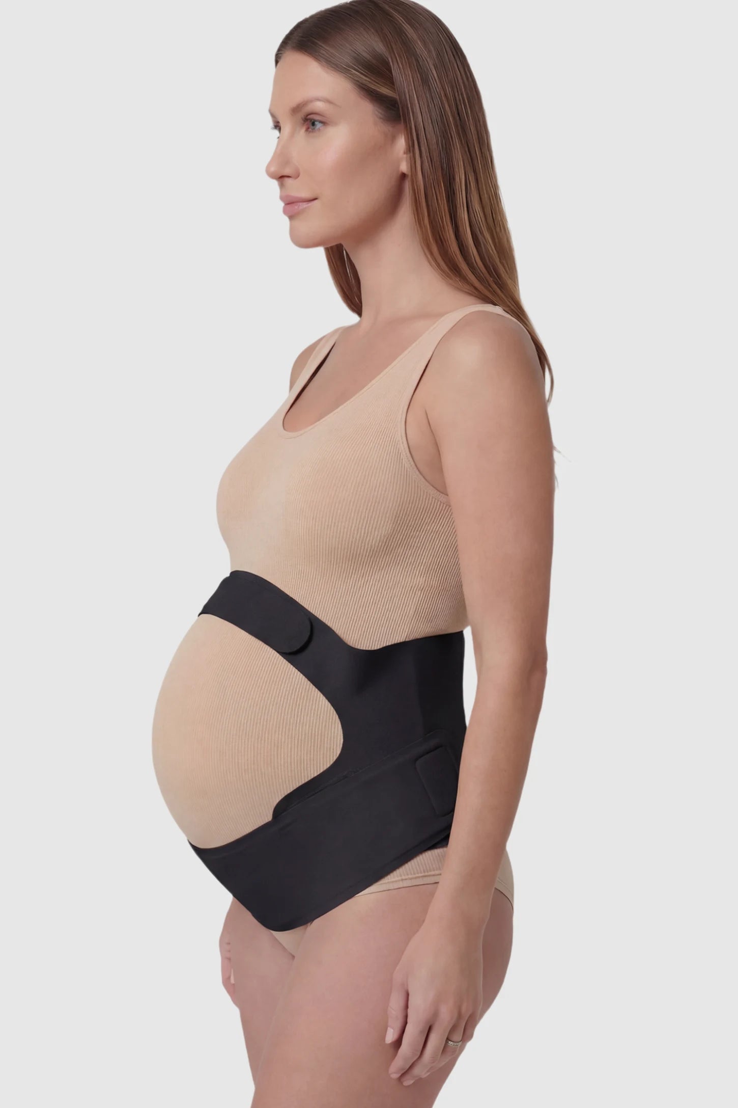 Adjustable Ergonomic Maternity Belly Support Band Adjustable Ergonomic Maternity Belly Support Band in Black featuring an adjustable ergonomic dual-strap design on a pregnant model showing side.
