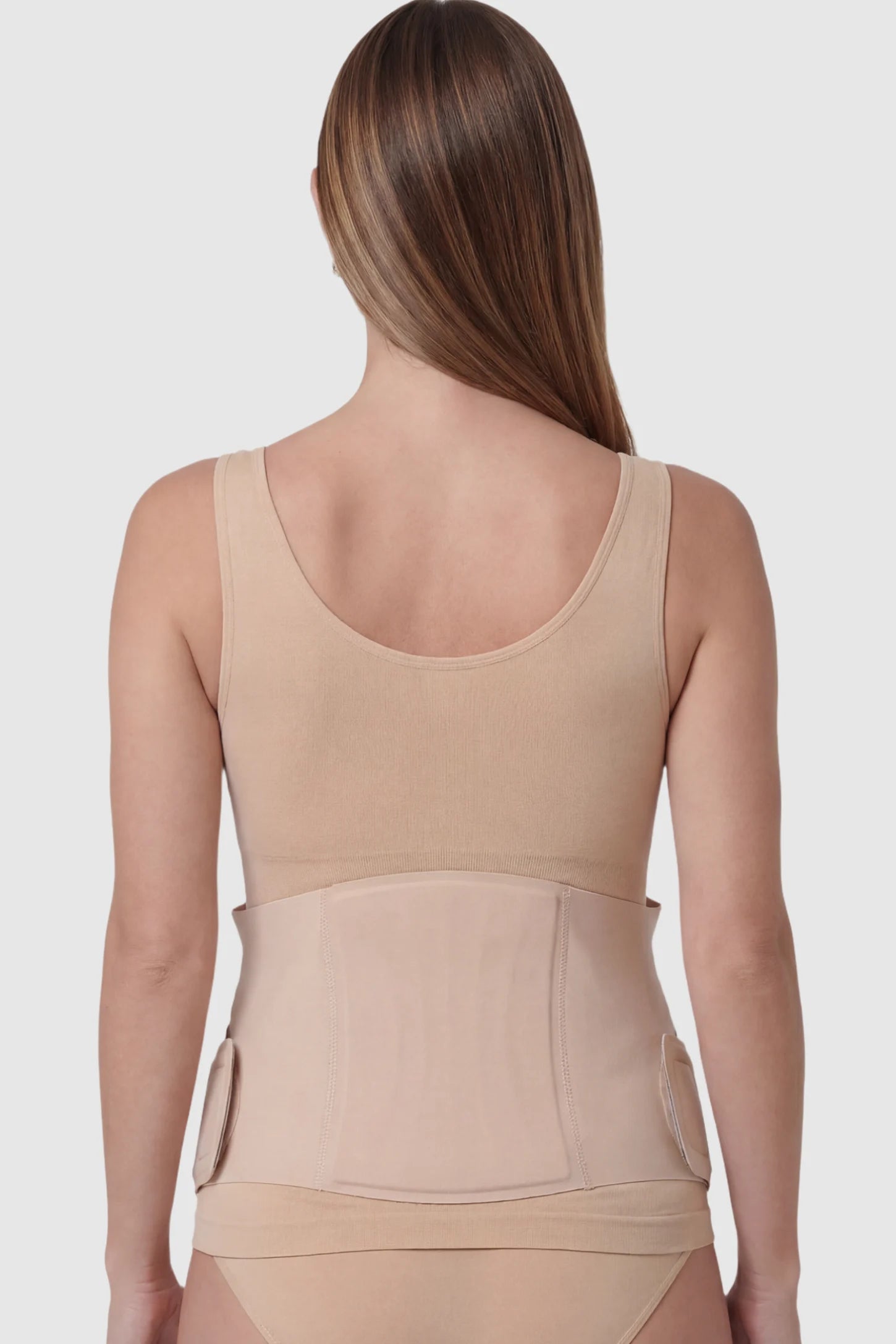 Adjustable Ergonomic Maternity Belly Support Band Adjustable Ergonomic Maternity Belly Support Band in Skin featuring an adjustable ergonomic design on a pregnant model showing back.