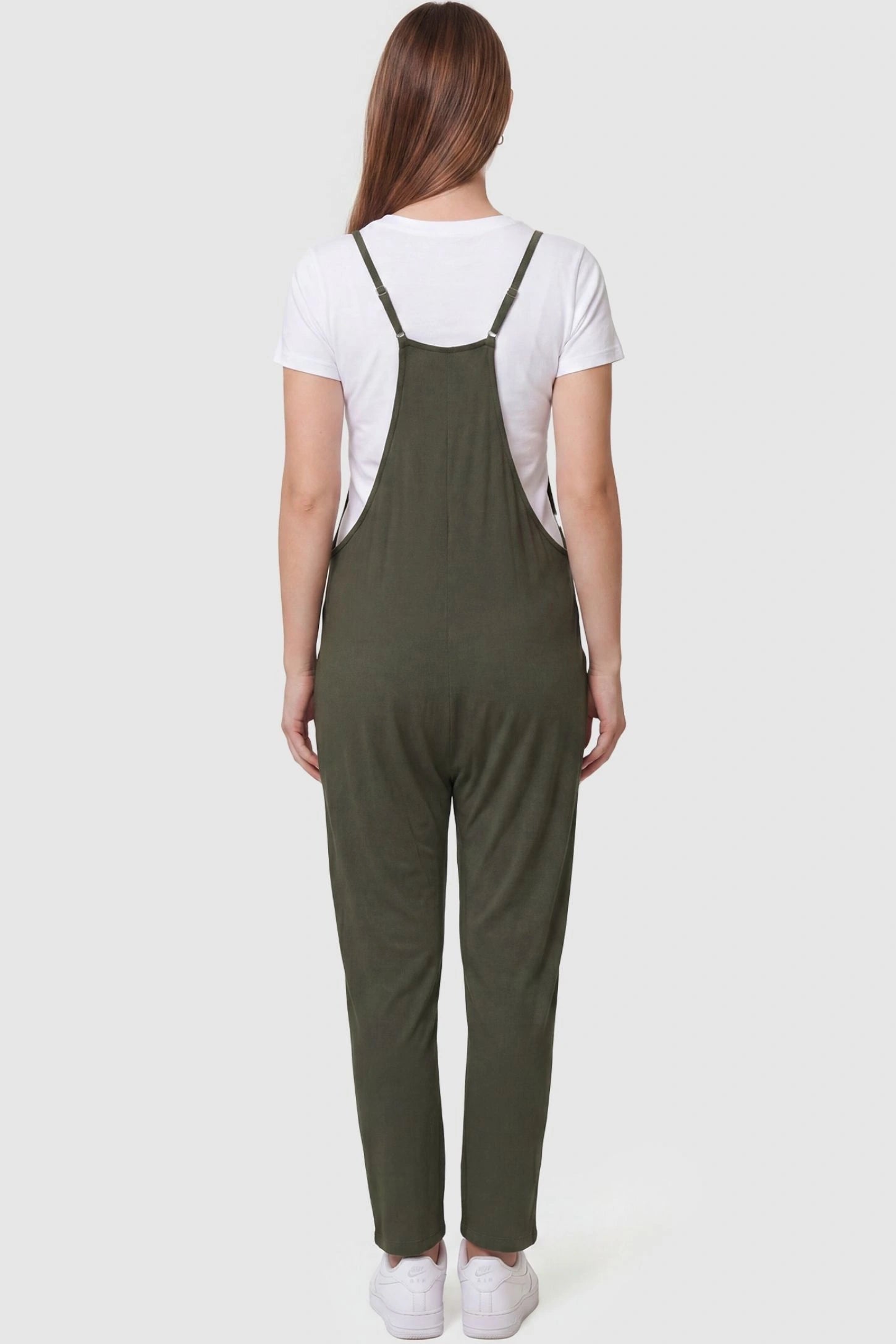 Adjustable Strap Pocketed Relaxed Maternity Jumpsuit Adjustable Strap Pocketed Maternity Jumpsuit in Army Green featuring adjustable shoulder straps on a pregnant model, back view.