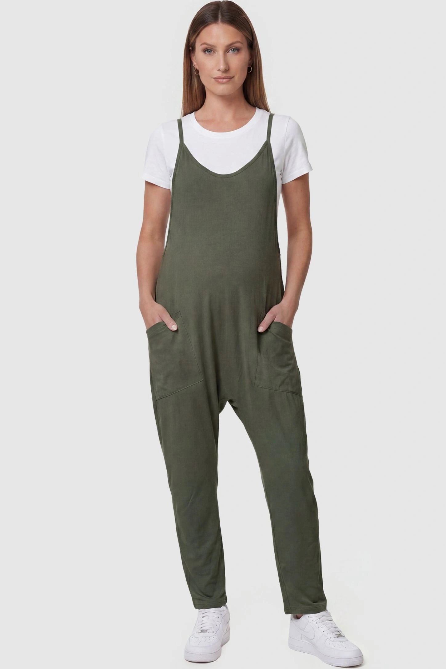 Adjustable Strap Pocketed Relaxed Maternity Jumpsuit Adjustable Strap Pocketed Maternity Jumpsuit in Army Green featuring a relaxed fit on a pregnant model, front view.