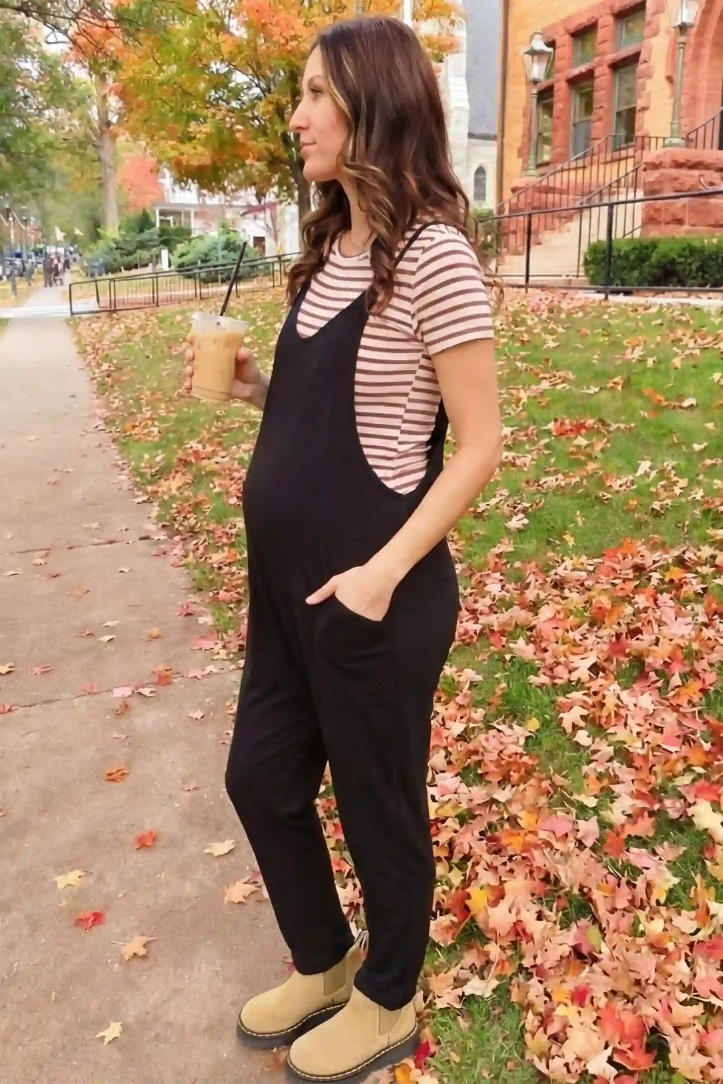 Adjustable Strap Pocketed Relaxed Maternity Jumpsuit Adjustable Strap Pocketed Maternity Jumpsuit in Black styled for everyday comfort on a pregnant model, lifestyle view.