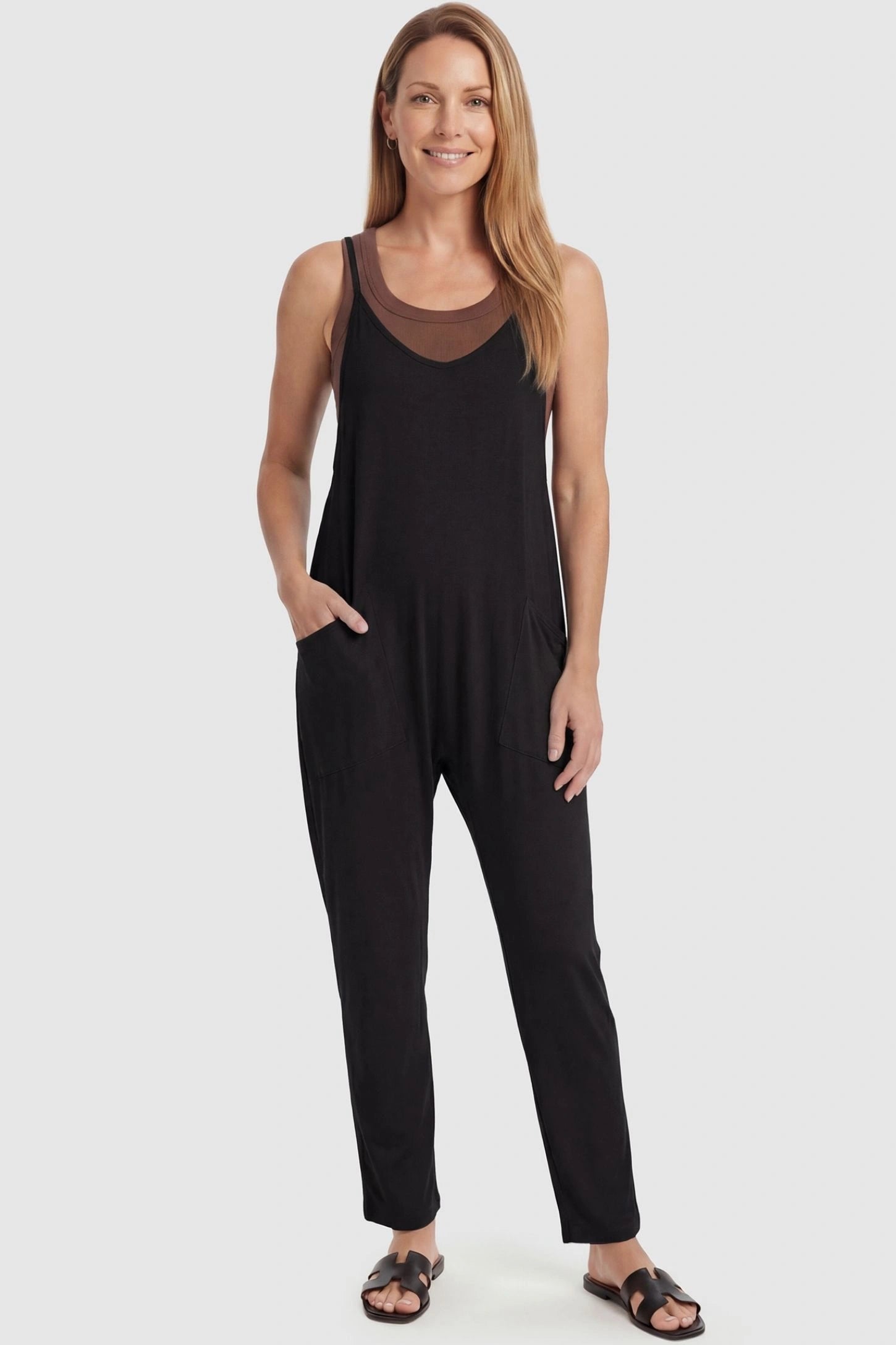 Adjustable Strap Pocketed Relaxed Maternity Jumpsuit Adjustable Strap Pocketed Maternity Jumpsuit in Black featuring a flexible fit on a non-pregnant model, front view.