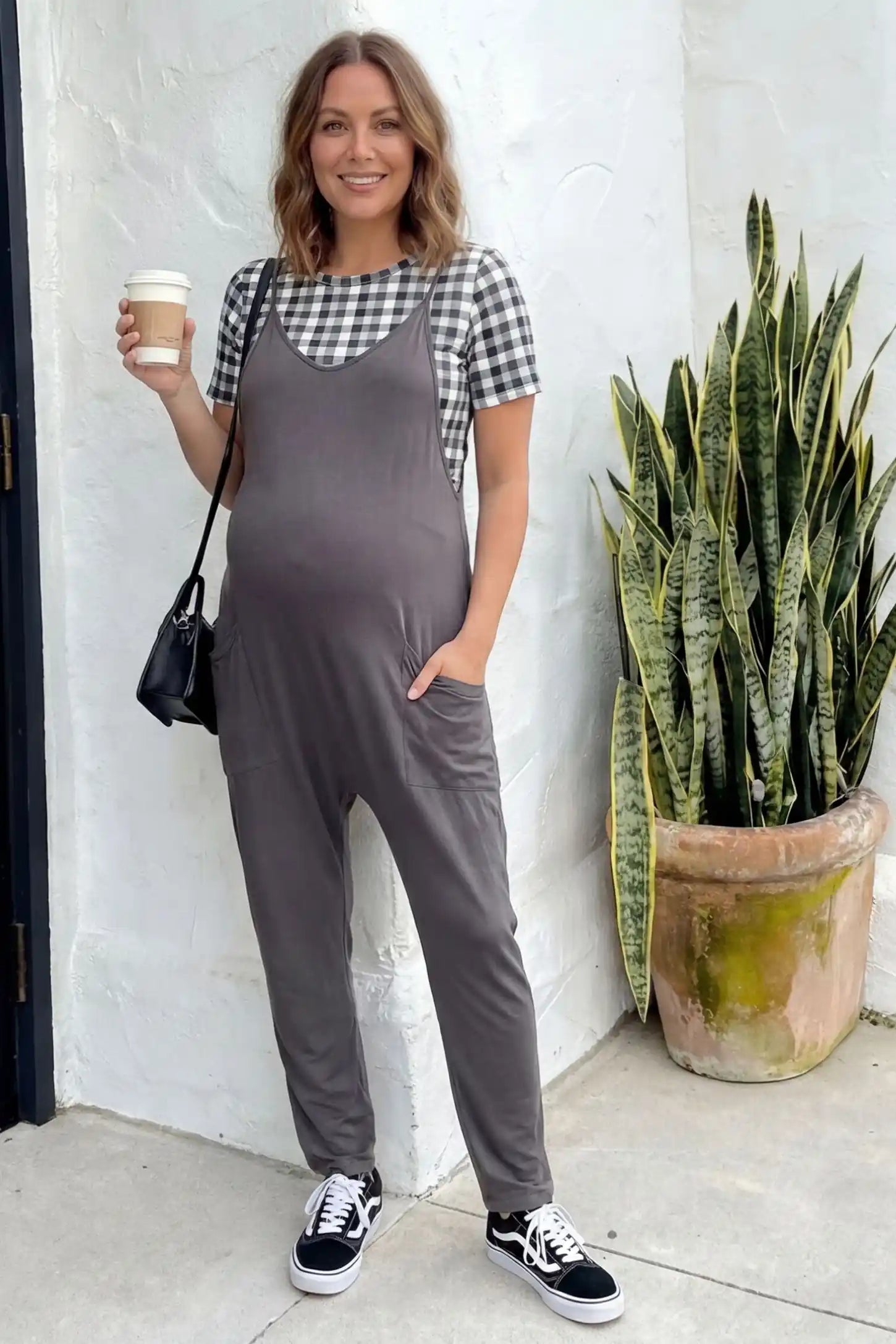 Adjustable Strap Pocketed Relaxed Maternity Jumpsuit Adjustable Strap Pocketed Maternity Jumpsuit in Dark Gray showing soft, breathable fabric on a pregnant model, lifestyle view.