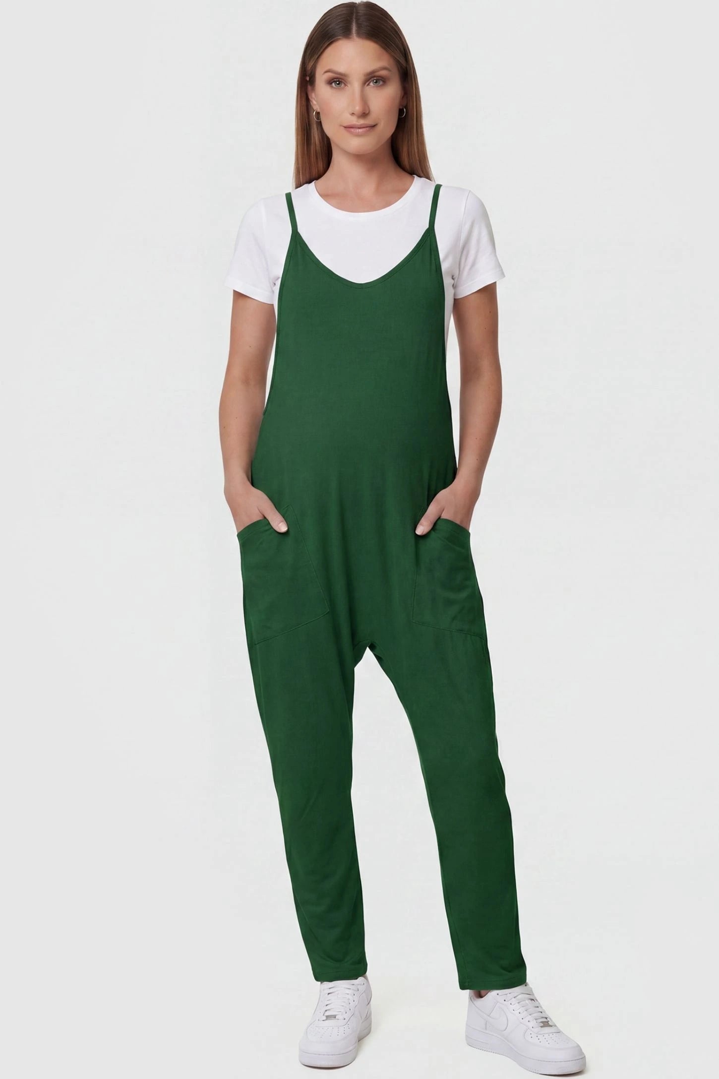 Adjustable Strap Pocketed Relaxed Maternity Jumpsuit Adjustable Strap Pocketed Maternity Jumpsuit in Dark Green featuring a relaxed fit on a pregnant model, front view.