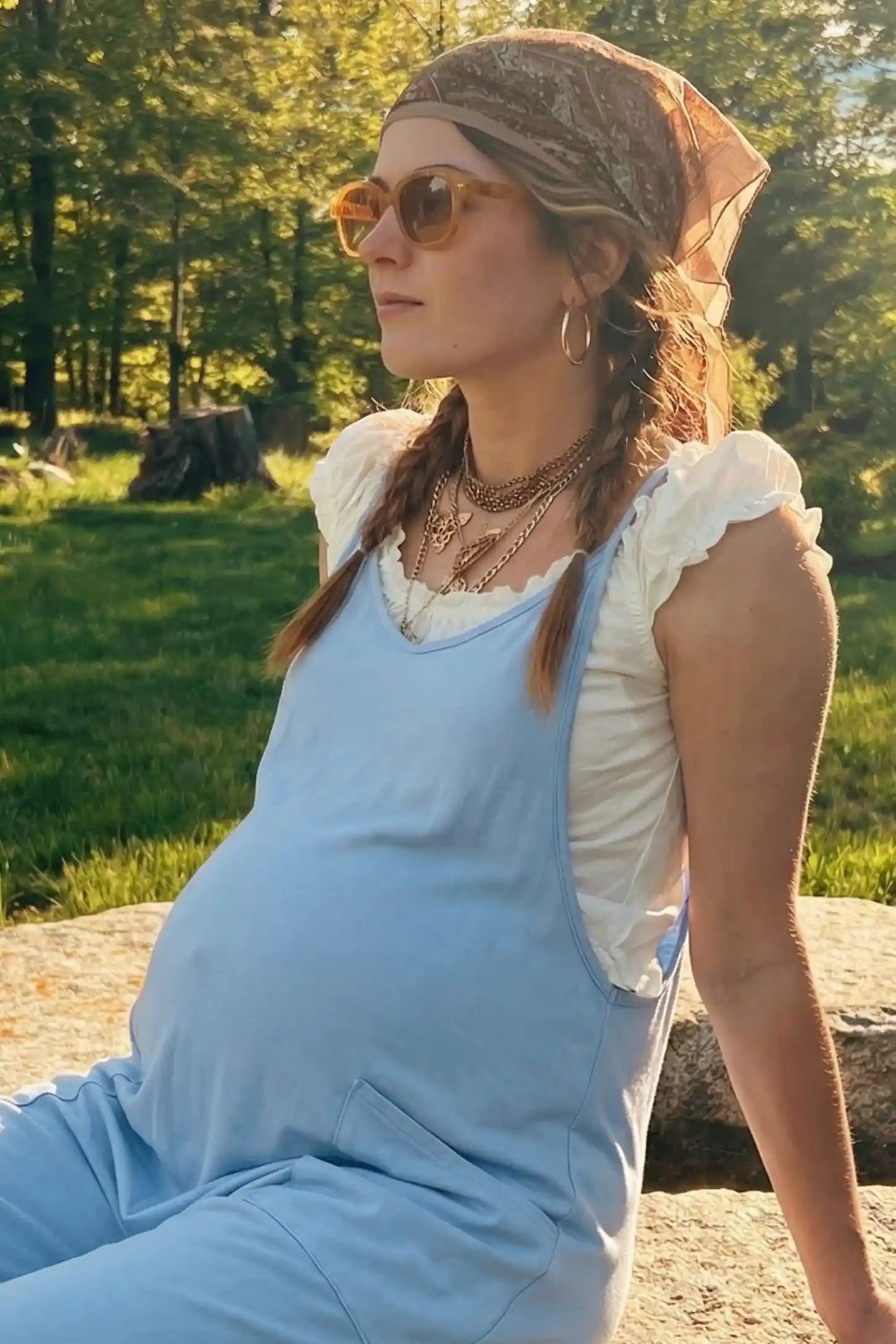 Adjustable Strap Pocketed Relaxed Maternity Jumpsuit Adjustable Strap Pocketed Maternity Jumpsuit in Light Blue showing soft, breathable fabric on a pregnant model, lifestyle view.