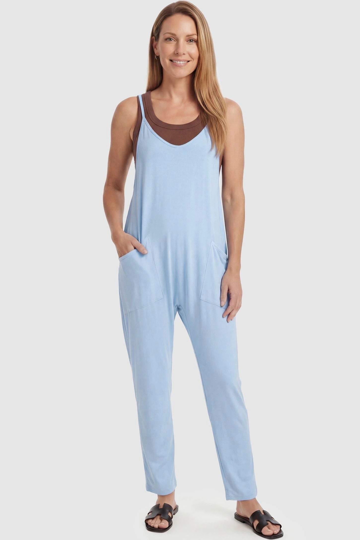 Adjustable Strap Pocketed Relaxed Maternity Jumpsuit Adjustable Strap Pocketed Maternity Jumpsuit in Light Blue featuring a flexible fit on a non-pregnant model, front view.