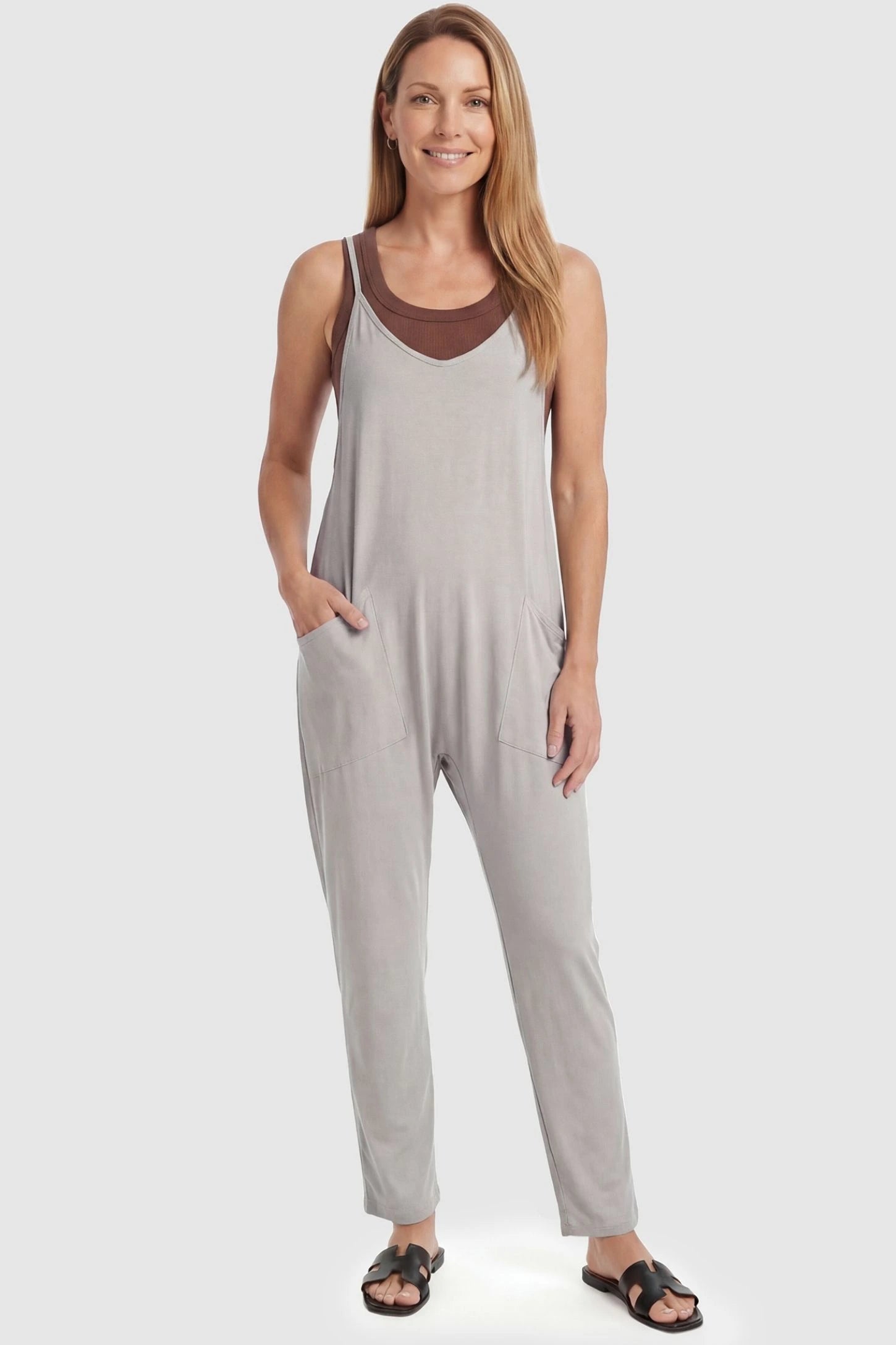 Adjustable Strap Pocketed Relaxed Maternity Jumpsuit Adjustable Strap Pocketed Maternity Jumpsuit in Light Gray featuring a flexible fit on a non-pregnant model, front view.
