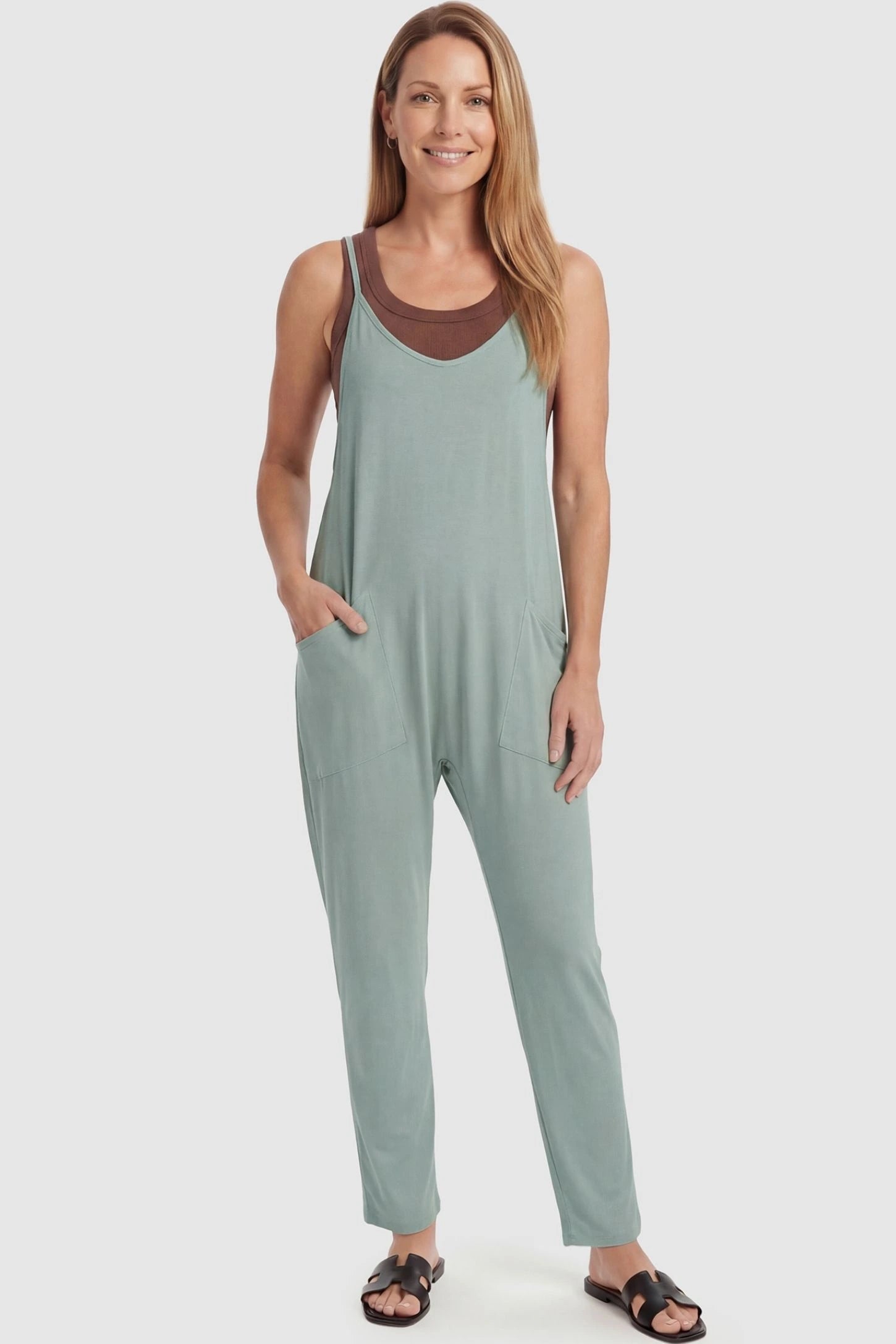 Adjustable Strap Pocketed Relaxed Maternity Jumpsuit Adjustable Strap Pocketed Maternity Jumpsuit in Light Green featuring a flexible fit on a non-pregnant model, front view.