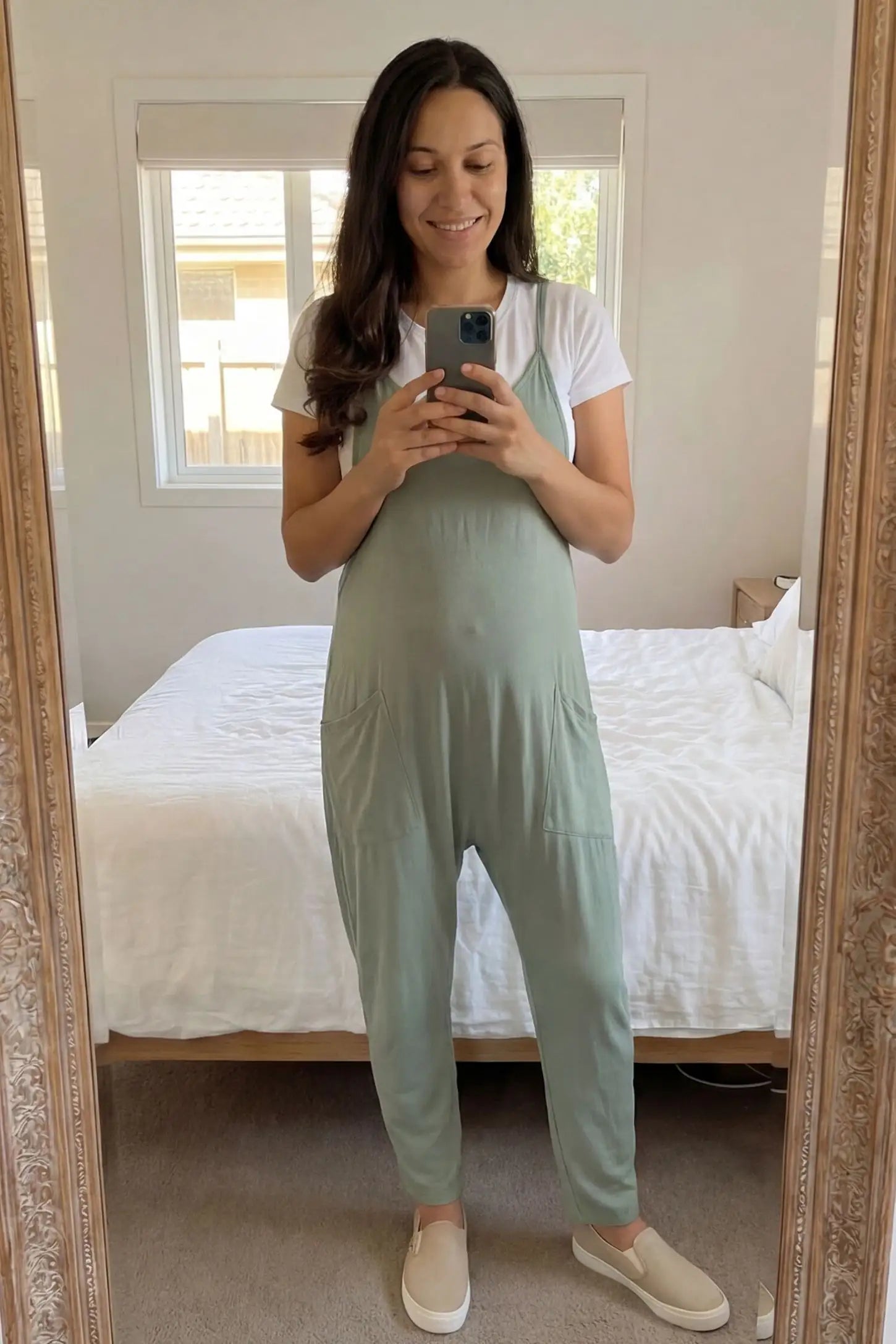 Adjustable Strap Pocketed Relaxed Maternity Jumpsuit Adjustable Strap Pocketed Maternity Jumpsuit in Light Green showing soft, breathable fabric on a pregnant model, lifestyle view.