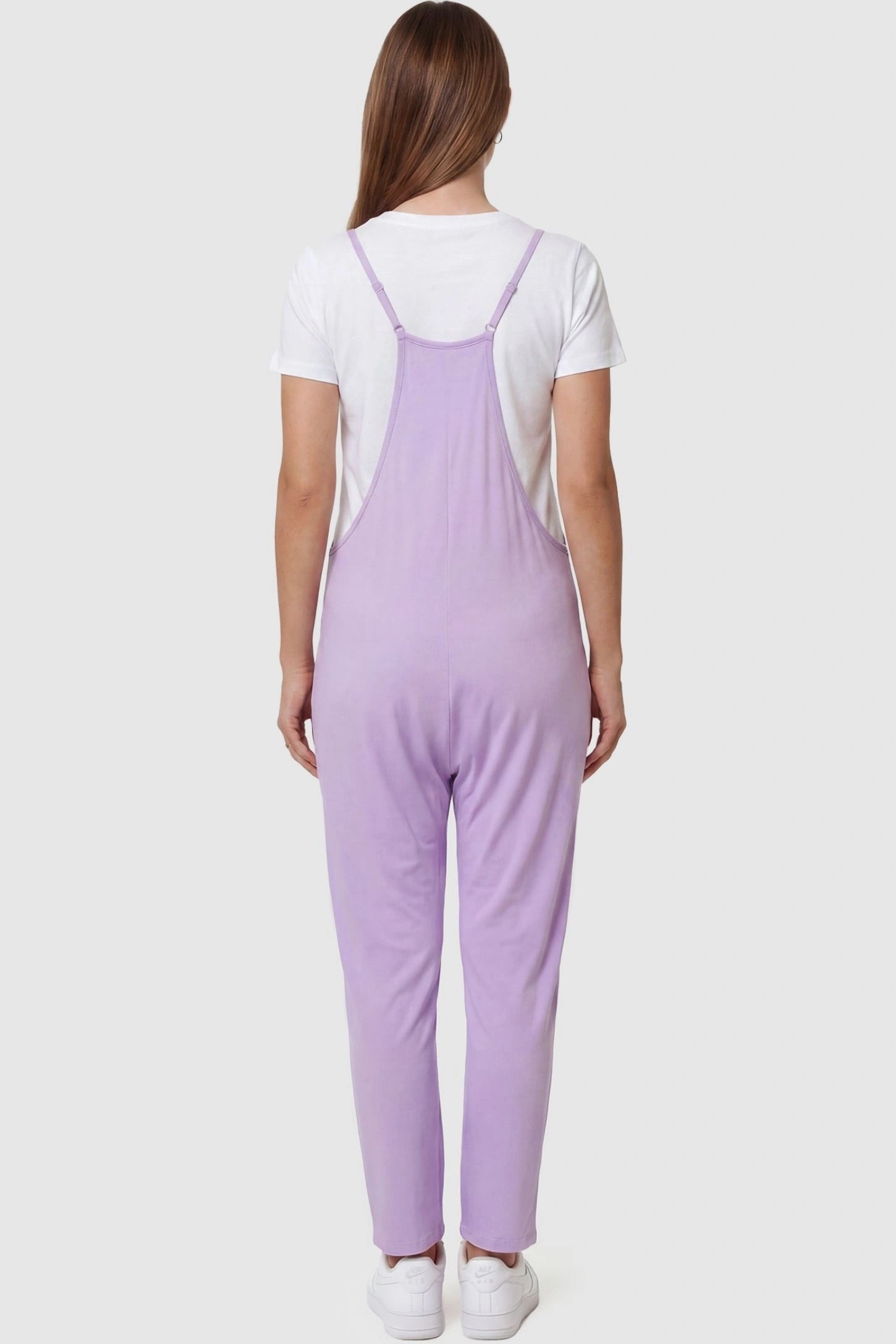 Adjustable Strap Pocketed Relaxed Maternity Jumpsuit Adjustable Strap Pocketed Maternity Jumpsuit in Purple featuring adjustable shoulder straps on a pregnant model, back view.