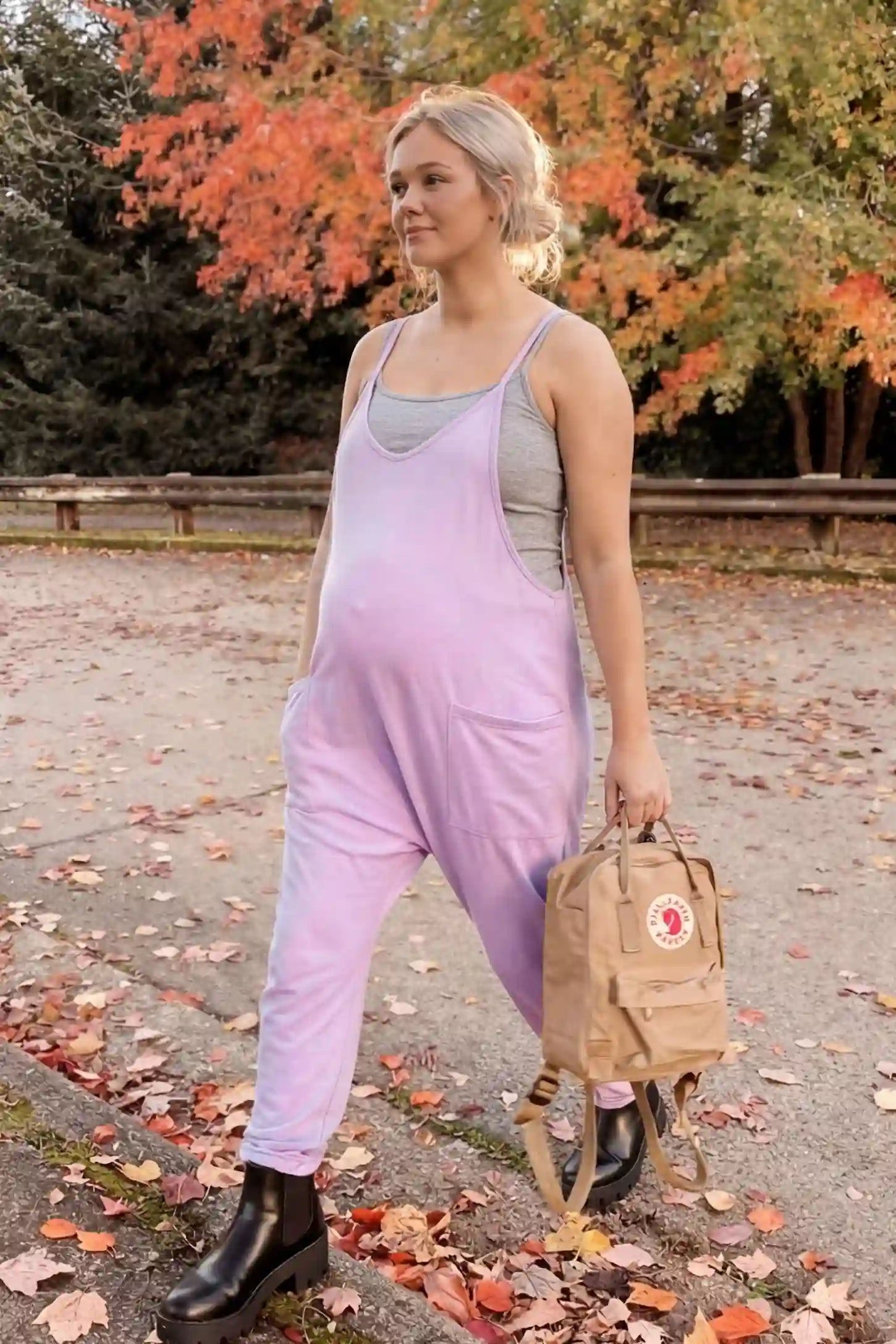 Adjustable Strap Pocketed Relaxed Maternity Jumpsuit Adjustable Strap Pocketed Maternity Jumpsuit in Purple showing soft, breathable fabric on a pregnant model, lifestyle view.