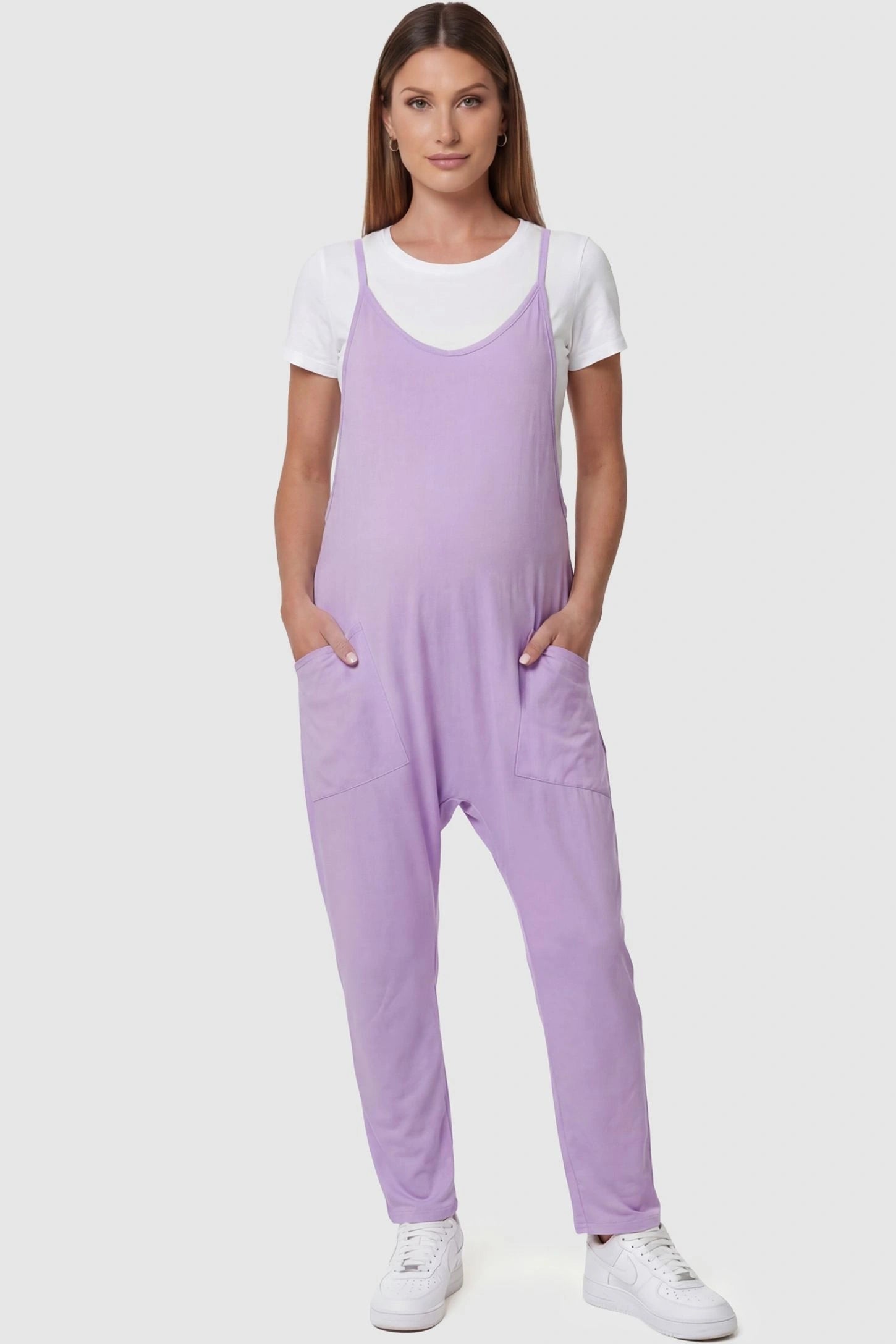 Adjustable Strap Pocketed Relaxed Maternity Jumpsuit Adjustable Strap Pocketed Maternity Jumpsuit in Purple featuring a relaxed fit on a pregnant model, front view.