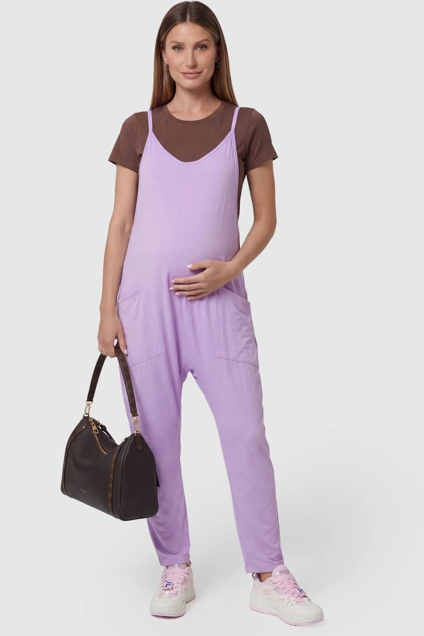 Adjustable Strap Pocketed Relaxed Maternity Jumpsuit Adjustable Strap Pocketed Maternity Jumpsuit in Purple featuring a relaxed fit on a pregnant model, front view.