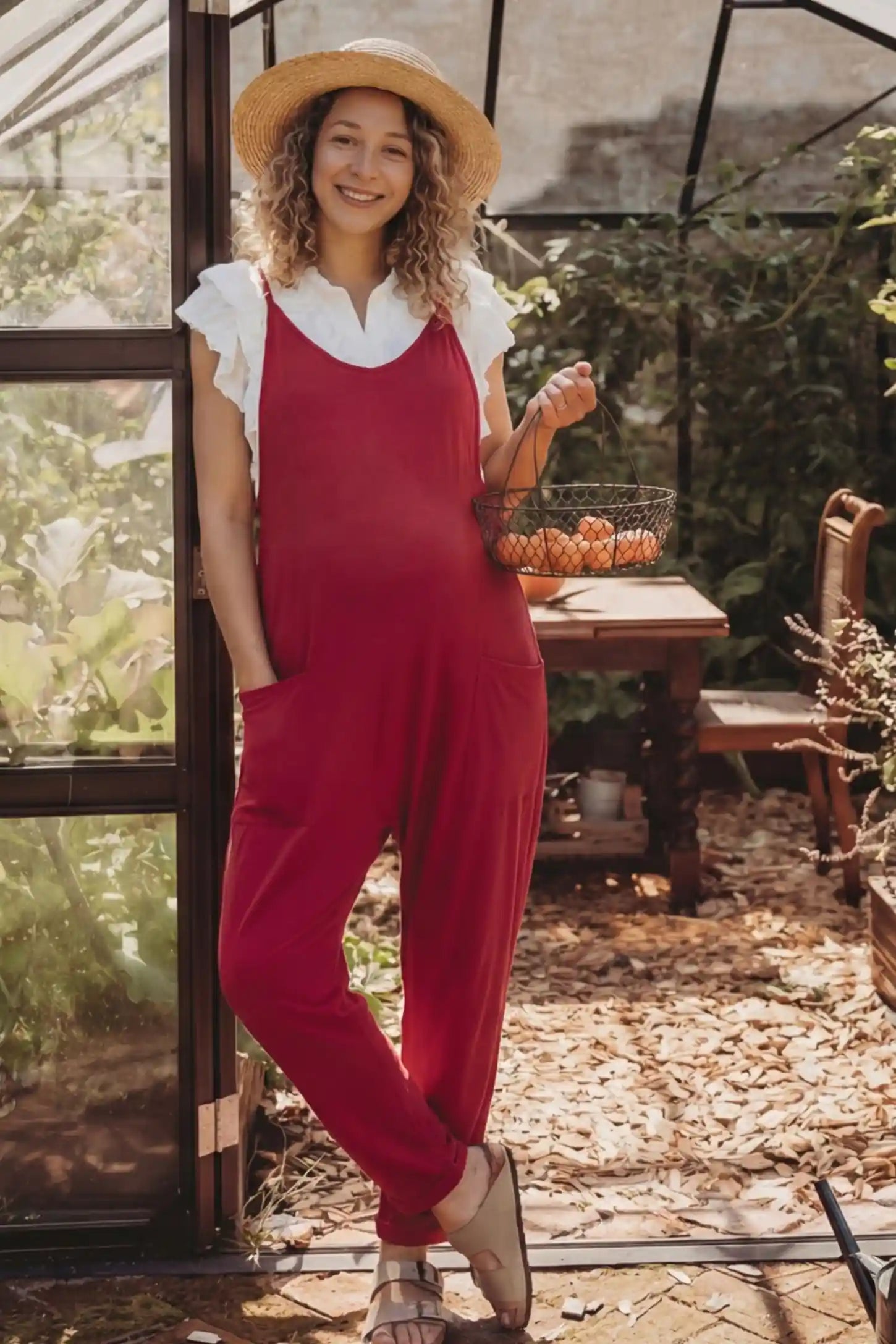 Adjustable Strap Pocketed Relaxed Maternity Jumpsuit Adjustable Strap Pocketed Maternity Jumpsuit in Wine Red showing soft, breathable fabric on a pregnant model, lifestyle view.