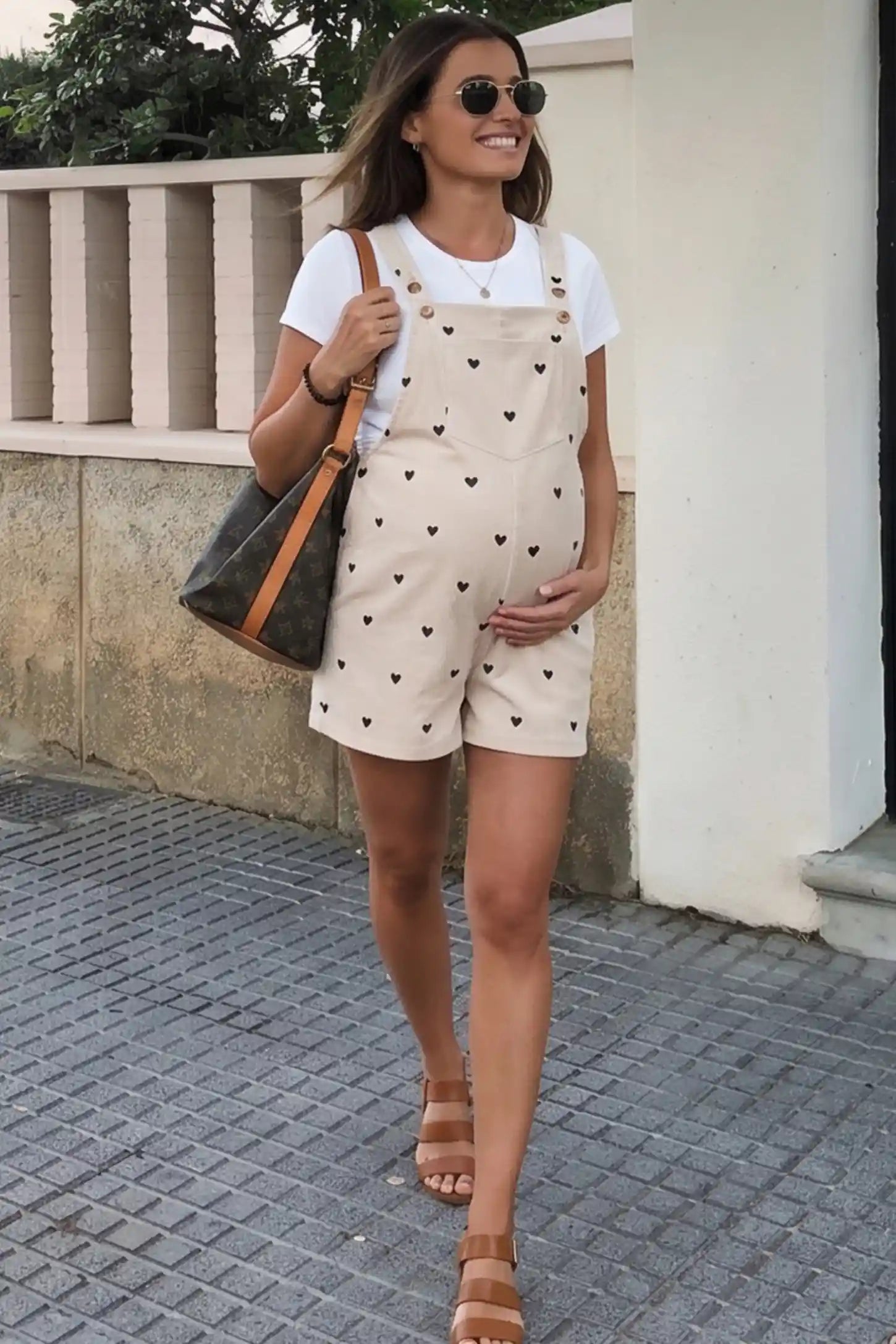 Adjustable Waist Front Pocket Maternity Short Overalls Adjustable Waist Front Pocket Maternity Short Overalls in black featuring an adjustable waist and front bib pocket on a pregnant woman in outdoor setting, front view.