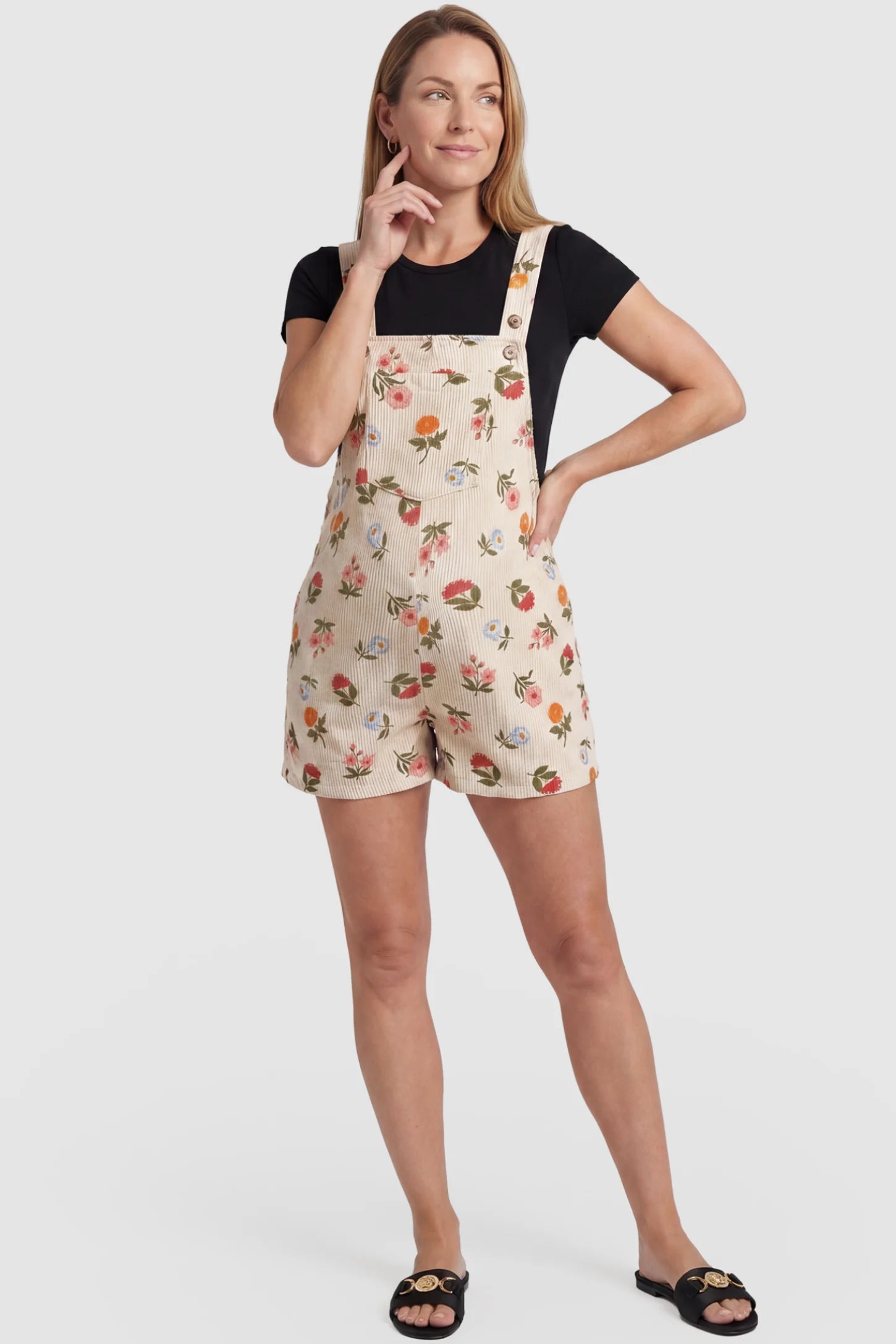 Adjustable Waist Front Pocket Maternity Short Overalls Adjustable Waist Front Pocket Maternity Short Overalls in floral featuring an adjustable waist and front bib pocket on a postpartum model, front view.