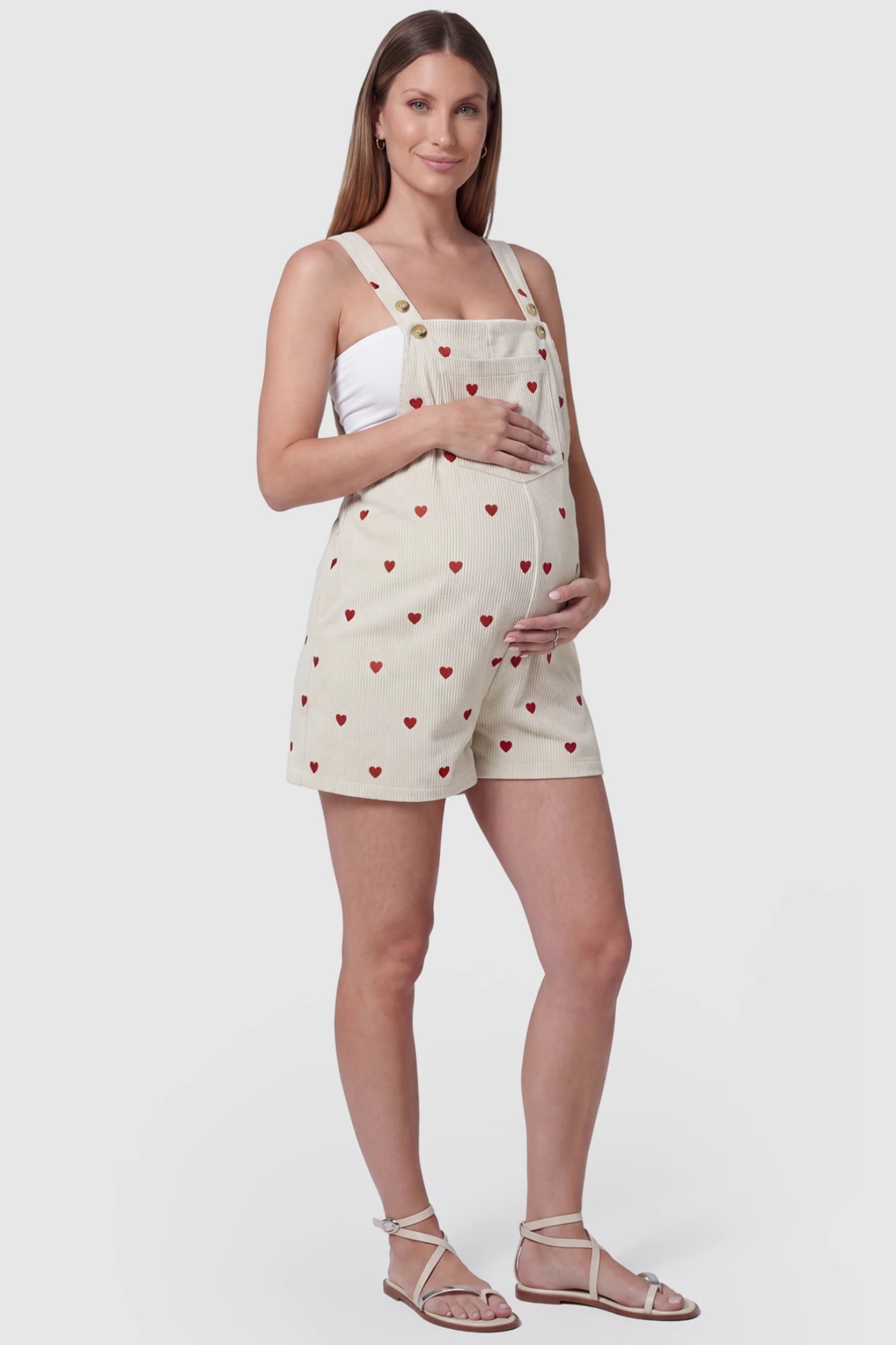 Adjustable Waist Front Pocket Maternity Short Overalls Adjustable Waist Front Pocket Maternity Short Overalls in red featuring an adjustable waist and front bib pocket on a pregnant model, side view.