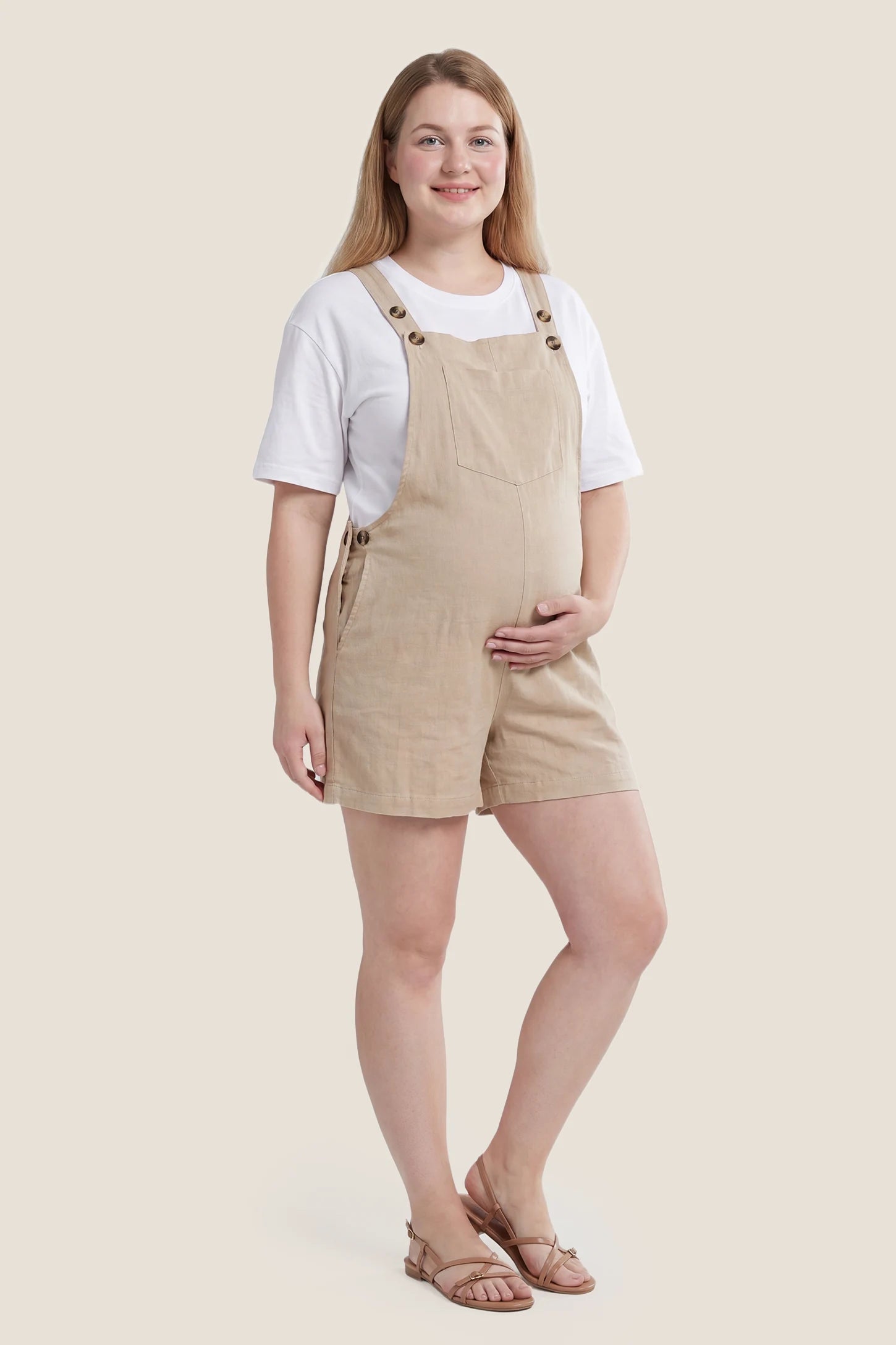 Adjustable Waist Pocketed Maternity Short Overalls Full body view of the beige Adjustable Waist Pocketed Maternity Short Overalls designed for comfortable maternity styling.