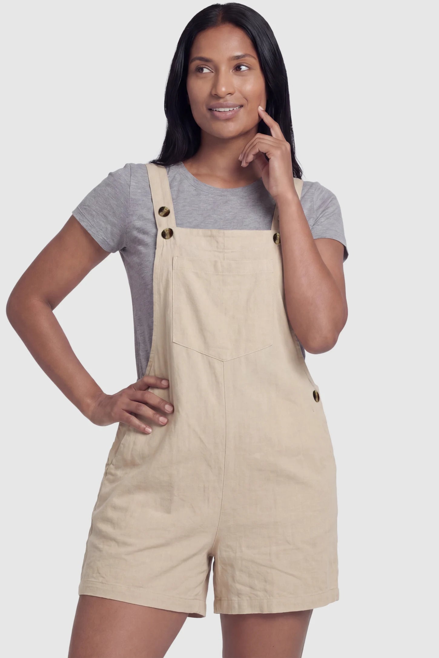 Adjustable Waist Pocketed Maternity Short Overalls Adjustable Waist Pocketed Maternity Short Overalls in Beige featuring a bib pocket on a postpartum model, front view.