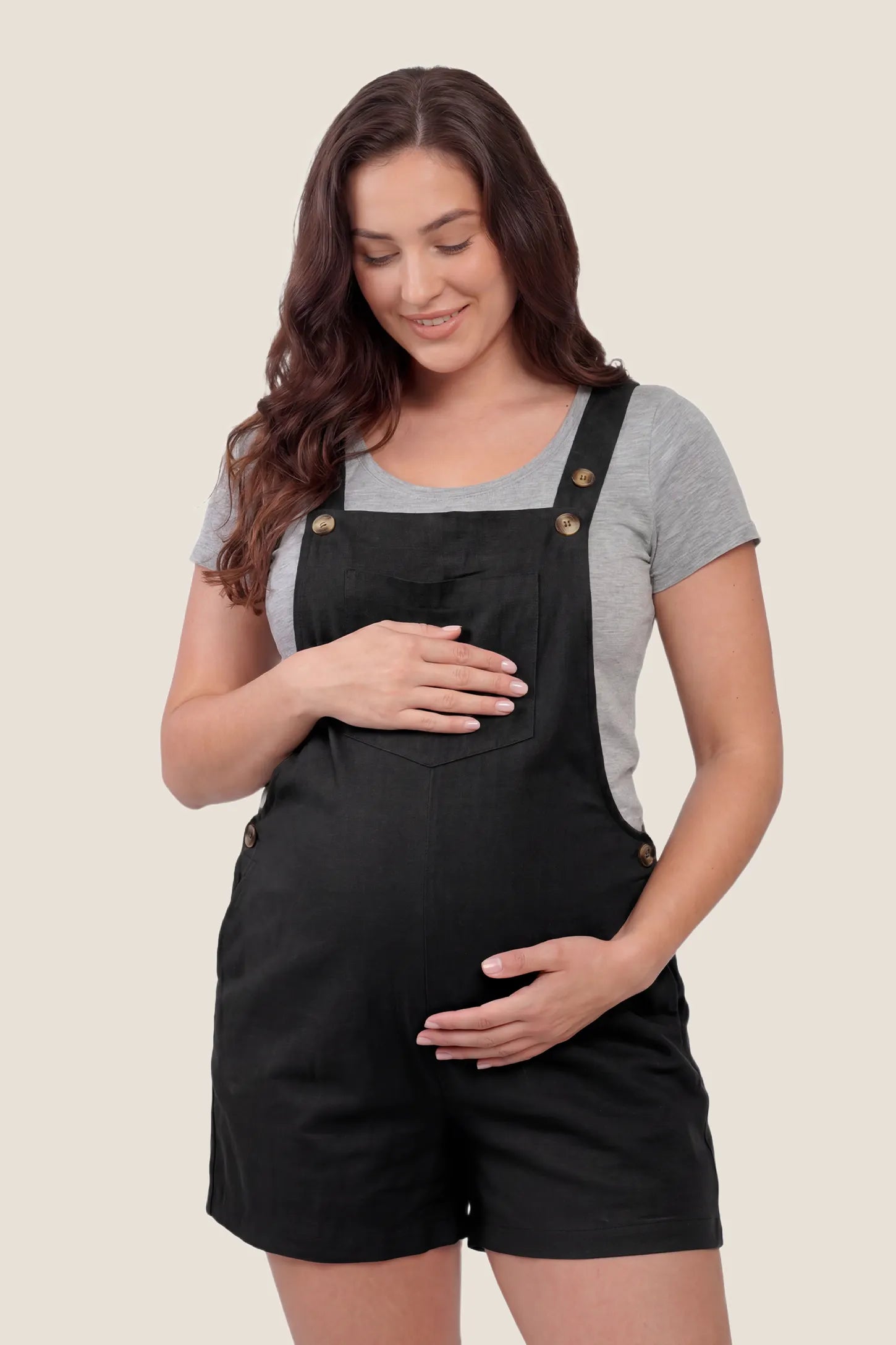 Adjustable Waist Pocketed Maternity Short Overalls Front view of the black Adjustable Waist Pocketed Maternity Short Overalls with pockets and an adjustable waist design.