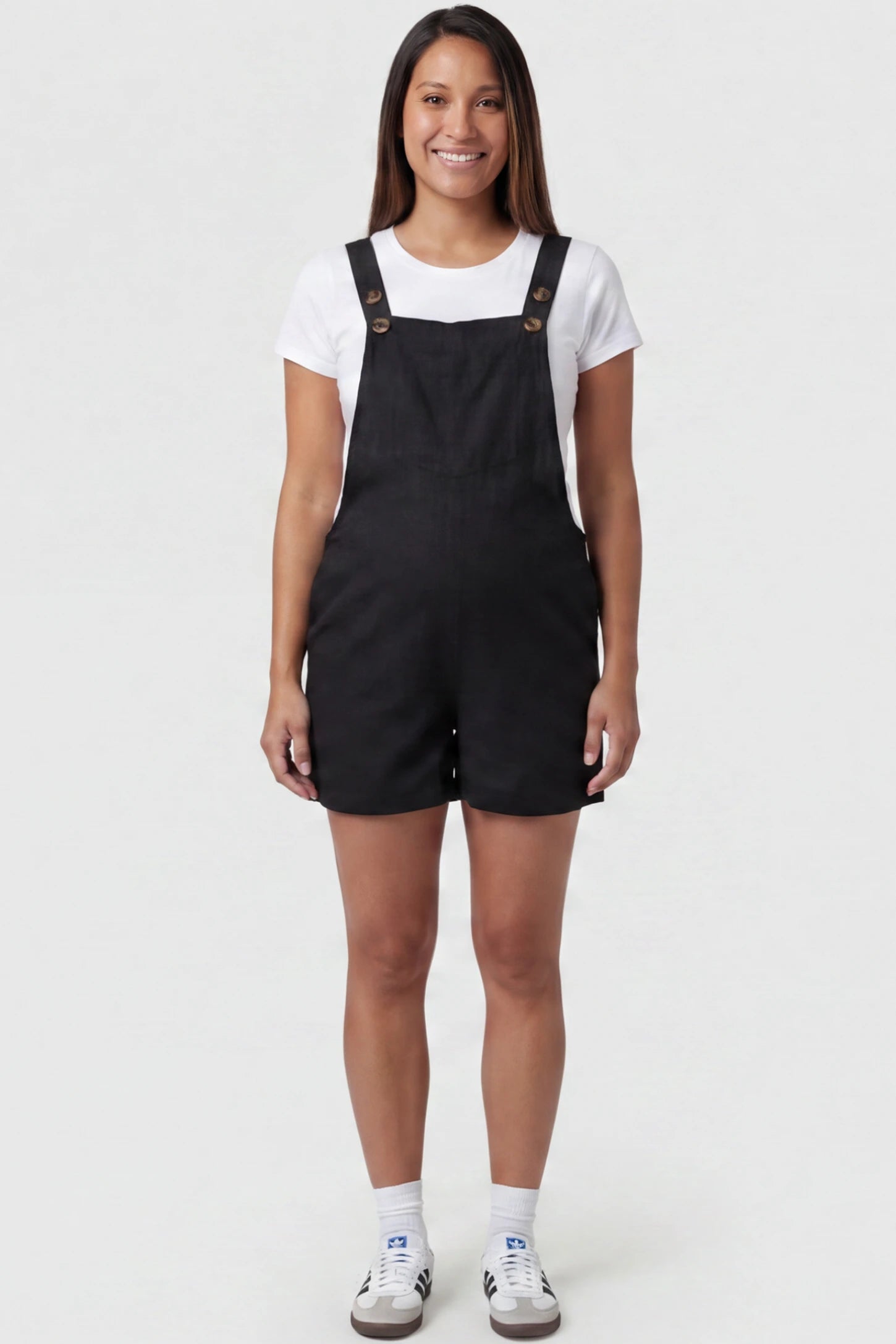 Adjustable Waist Pocketed Maternity Short Overalls Adjustable Waist Pocketed Maternity Short Overalls in Black featuring a bib pocket on a pregnant model, full body view.