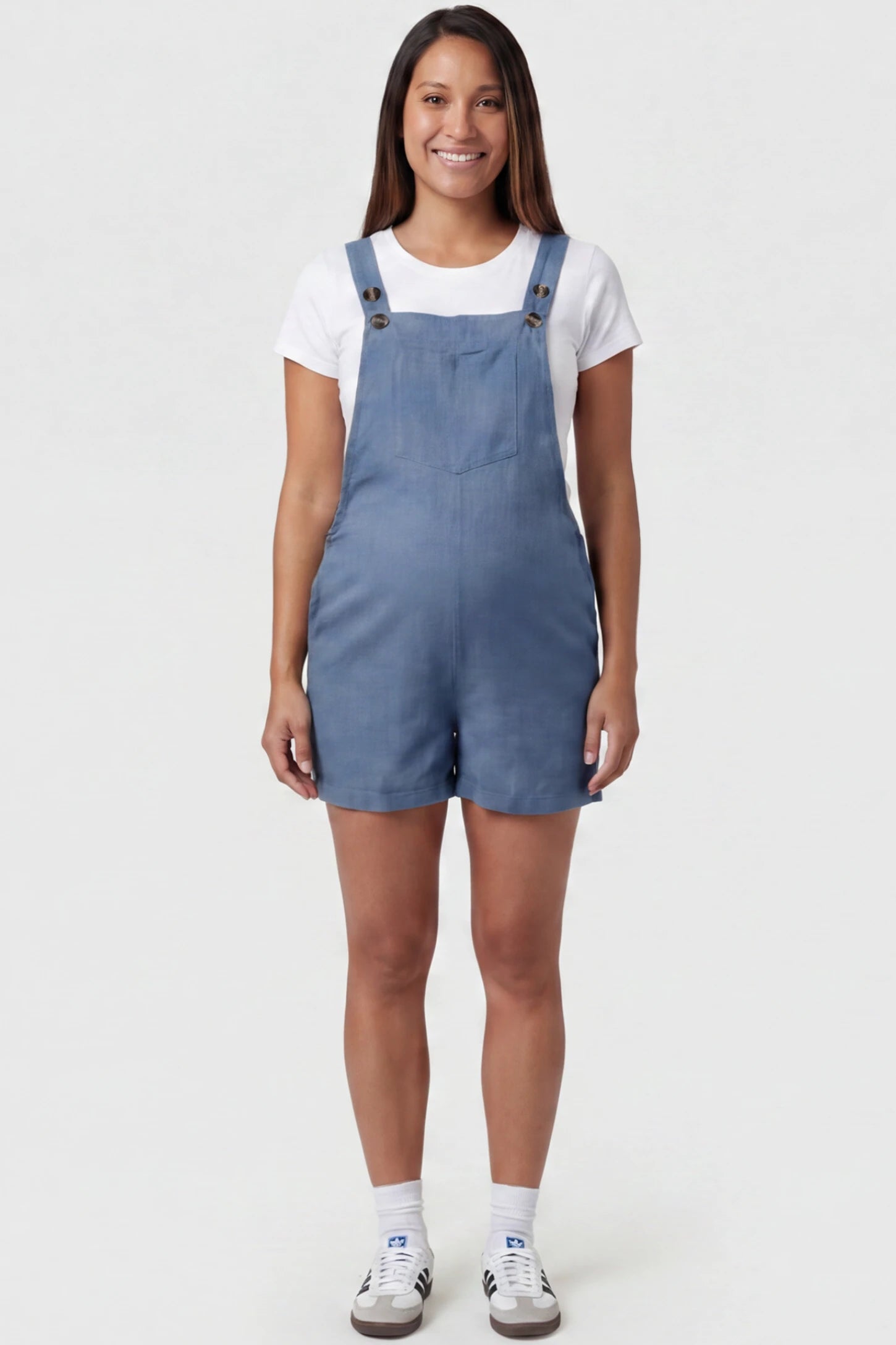 Adjustable Waist Pocketed Maternity Short Overalls Adjustable Waist Pocketed Maternity Short Overalls in Blue featuring a bib pocket on a pregnant model, full body view.