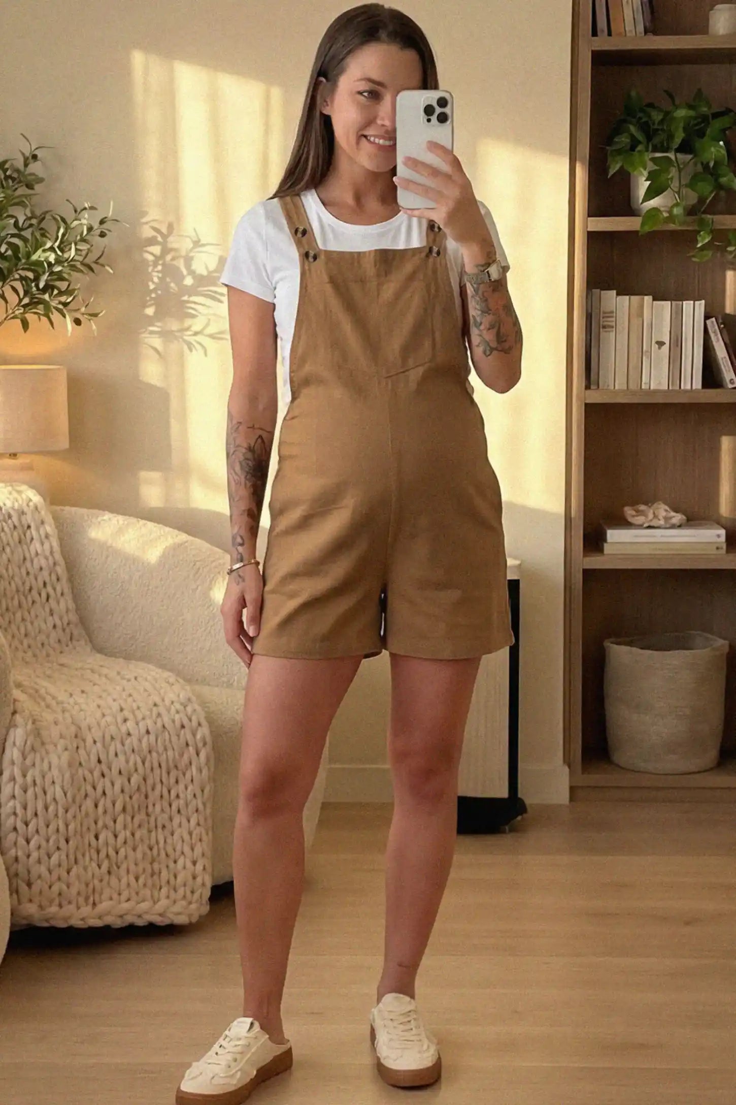 Adjustable Waist Pocketed Maternity Short Overalls Adjustable Waist Pocketed Maternity Short Overalls in Brown featuring a bib pocket on a pregnant woman in indoor setting, front view.