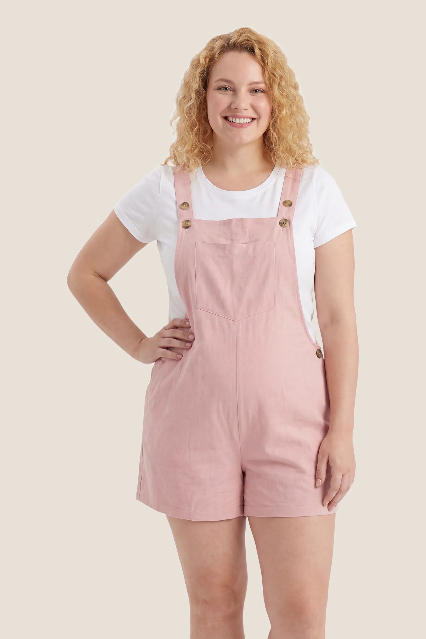 Adjustable Waist Pocketed Maternity Short Overalls After pregnancy view of the pink Adjustable Waist Pocketed Maternity Short Overalls showing an easy relaxed fit for postpartum wear.