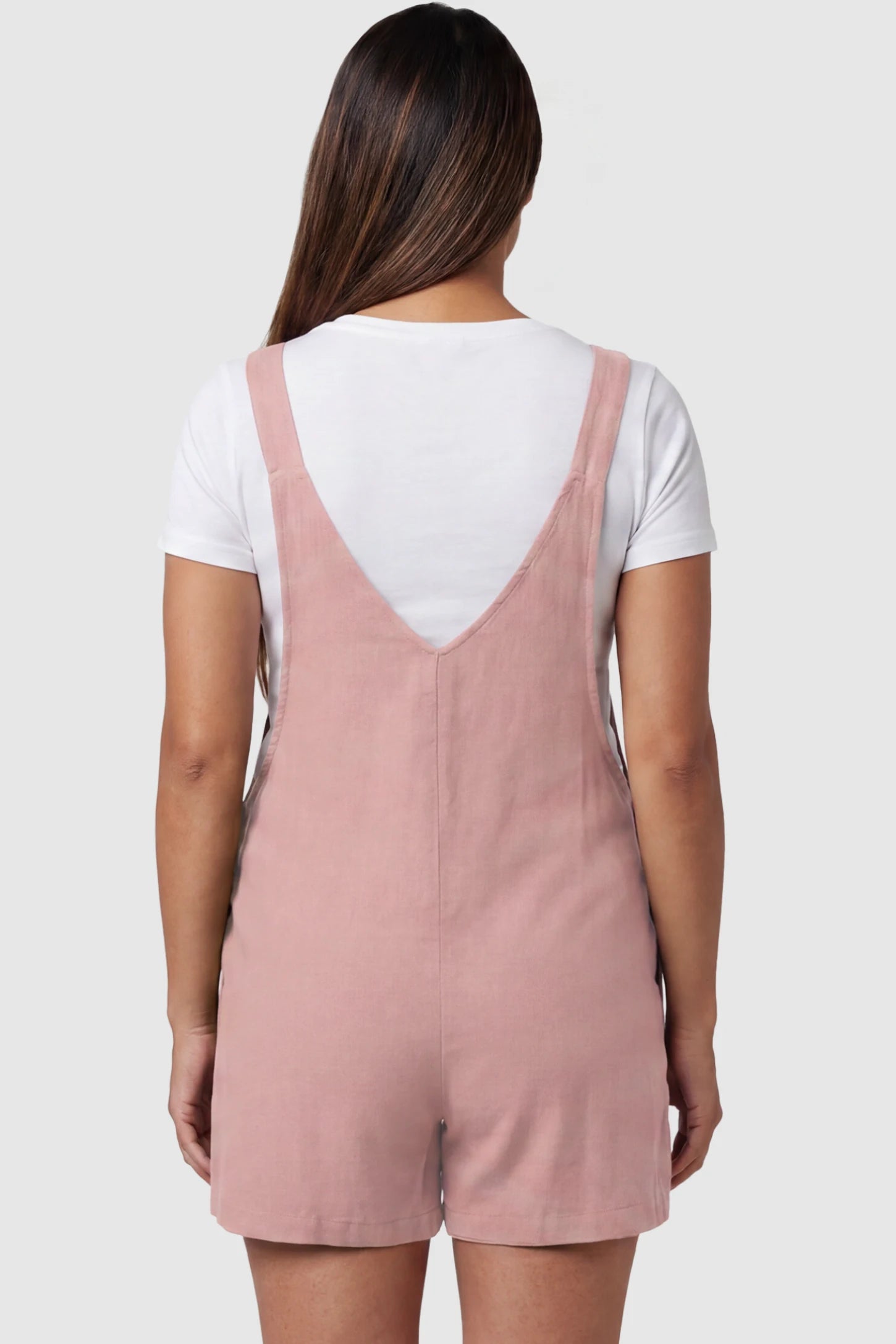 Adjustable Waist Pocketed Maternity Short Overalls Adjustable Waist Pocketed Maternity Short Overalls in Pink featuring a V-shaped back and wide straps on a model, back view.