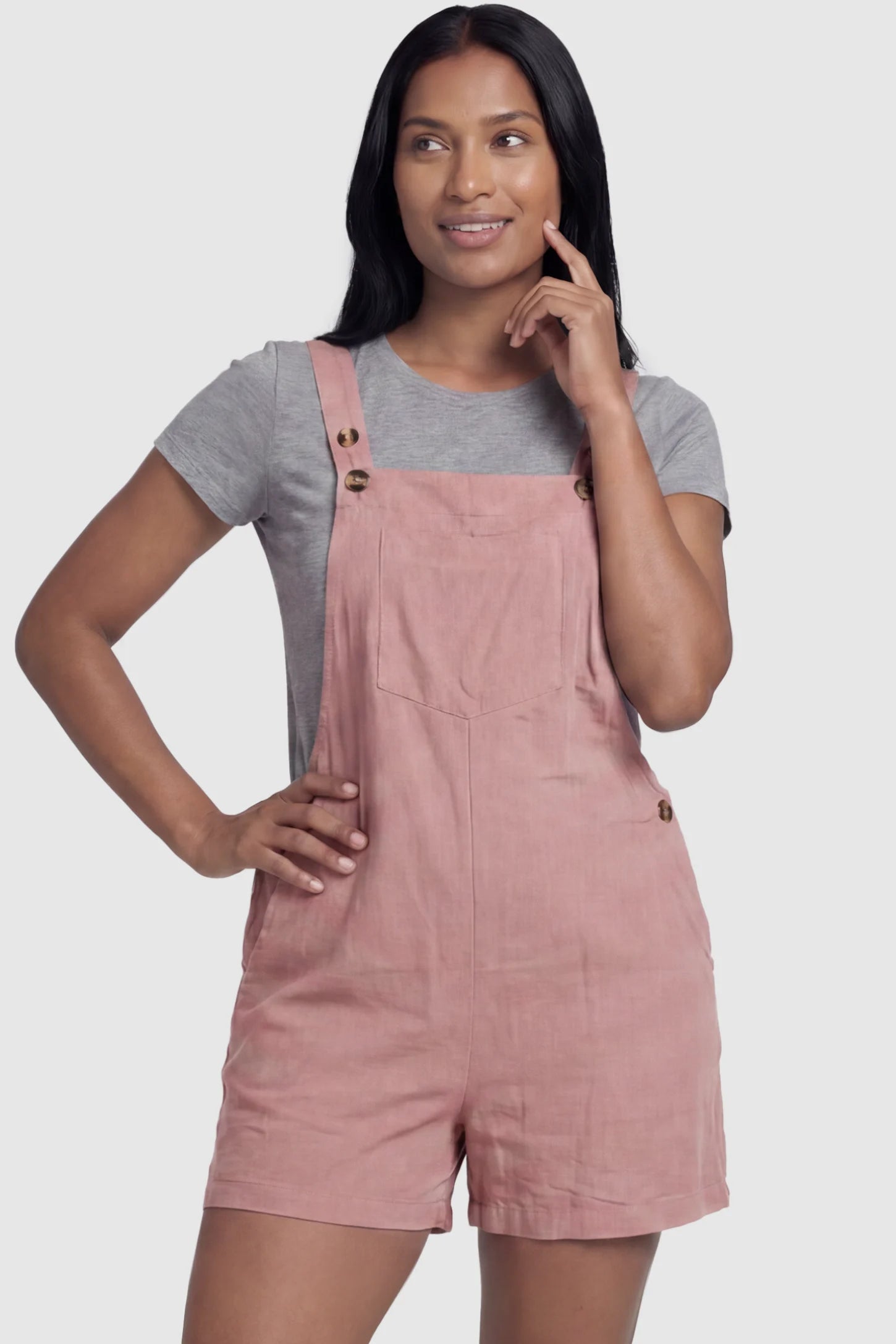 Adjustable Waist Pocketed Maternity Short Overalls Adjustable Waist Pocketed Maternity Short Overalls in Pink featuring a bib pocket on a postpartum model, front view.