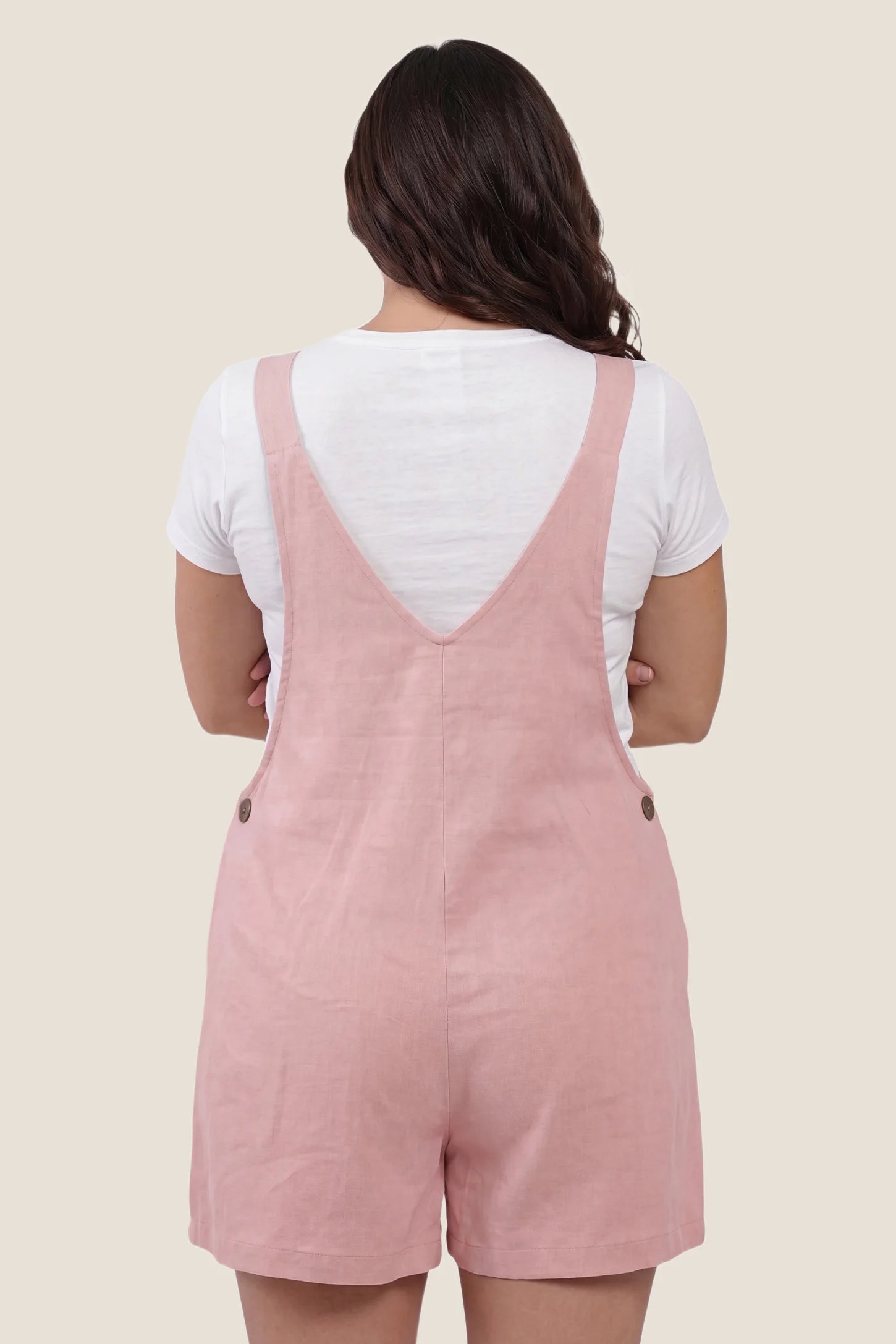 Adjustable Waist Pocketed Maternity Short Overalls Rear view of the pink Adjustable Waist Pocketed Maternity Short Overalls with a soft relaxed fit and short overall style.