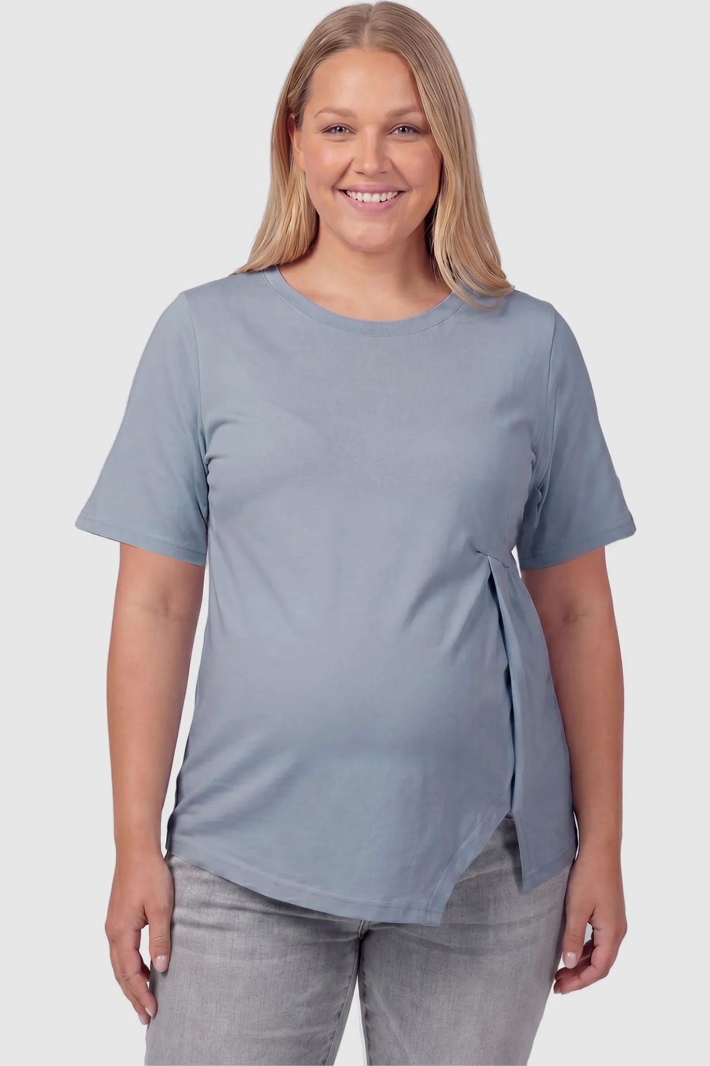Asymmetrical Hem Relaxed Short Sleeve Maternity Top Front view of Asymmetrical Hem Relaxed Short Sleeve Maternity Top in Blue featuring a stretchy cut on a plus-size pregnant model.