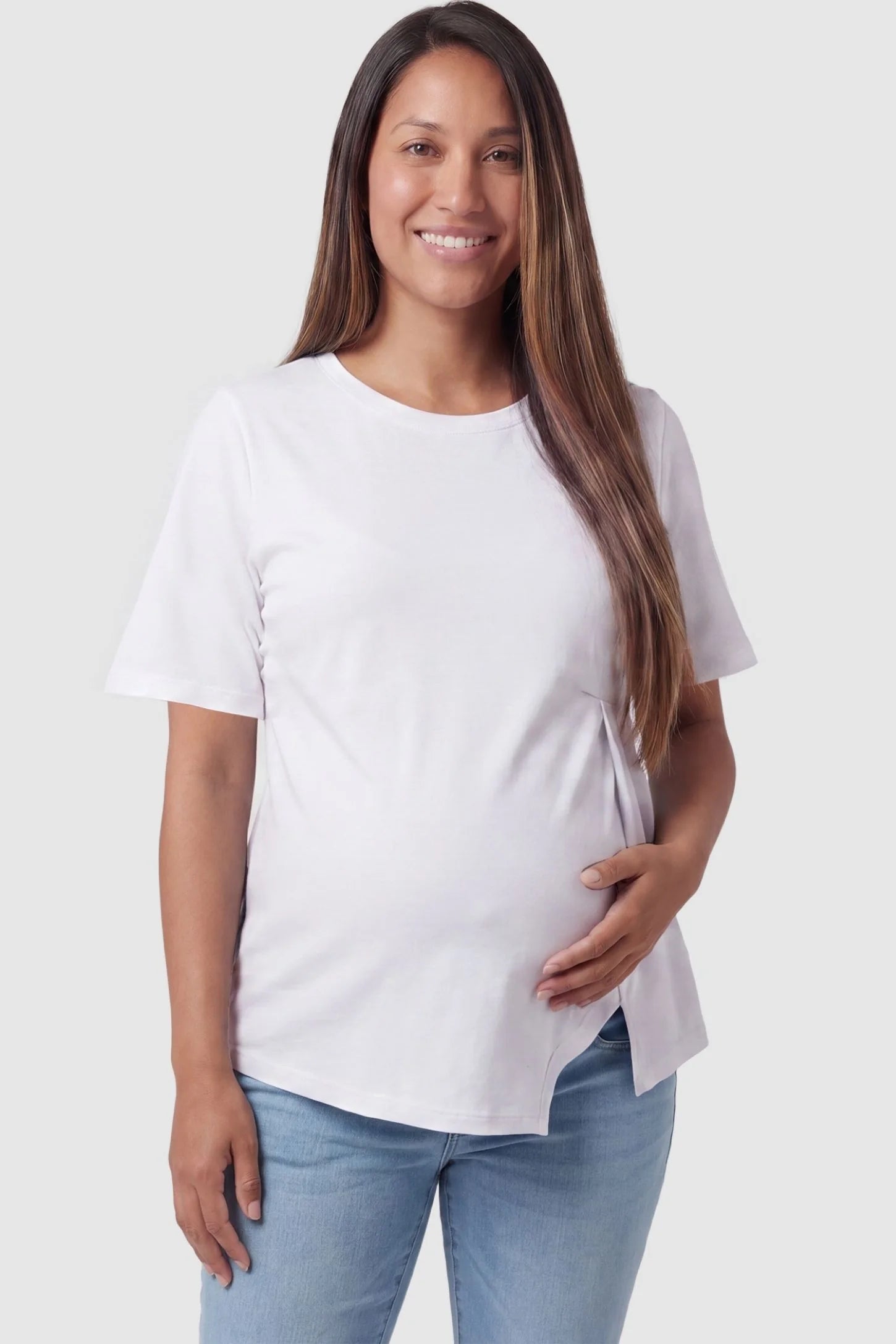 Asymmetrical Hem Relaxed Short Sleeve Maternity Top Front view of Asymmetrical Hem Relaxed Short Sleeve Maternity Top in White featuring a pleated front on a pregnant model.