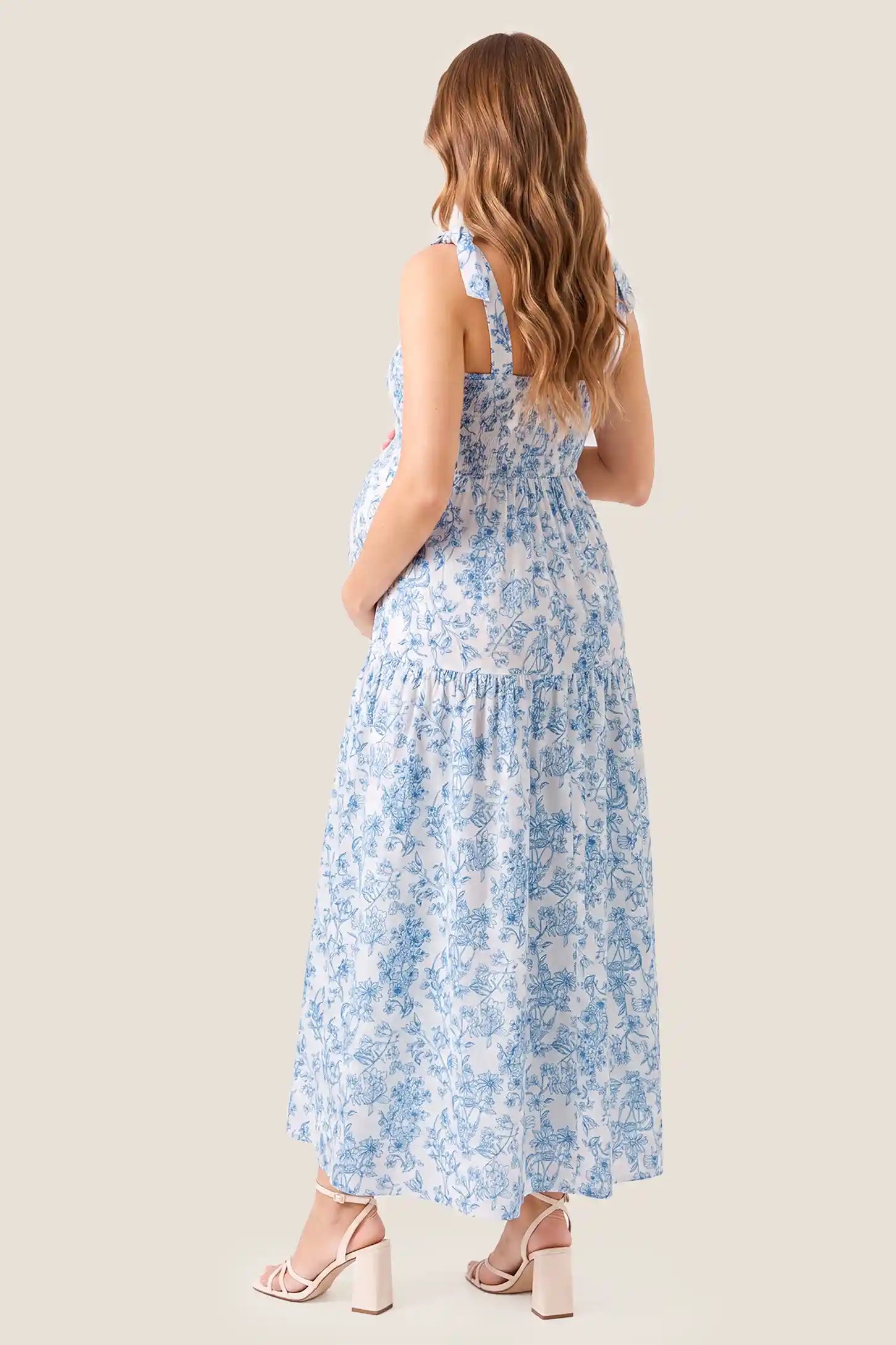 Floral Cami Tiered Maxi Maternity Dress Standard back view of the Floral Cami Tiered Maxi Maternity Dress, highlighting the smocked back panel for comfort.