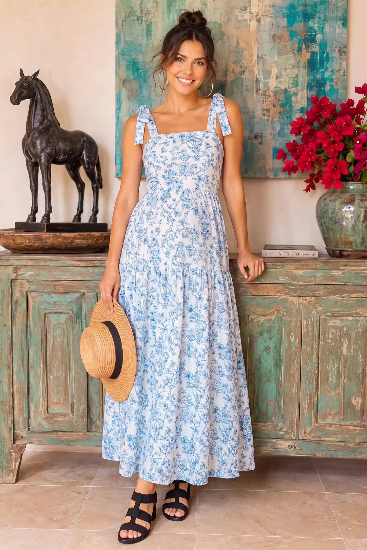 Floral Cami Tiered Maxi Maternity Dress Blue and white floral cami maternity tiered maxi dress on a pregnant model, showcasing the light and airy fabric.