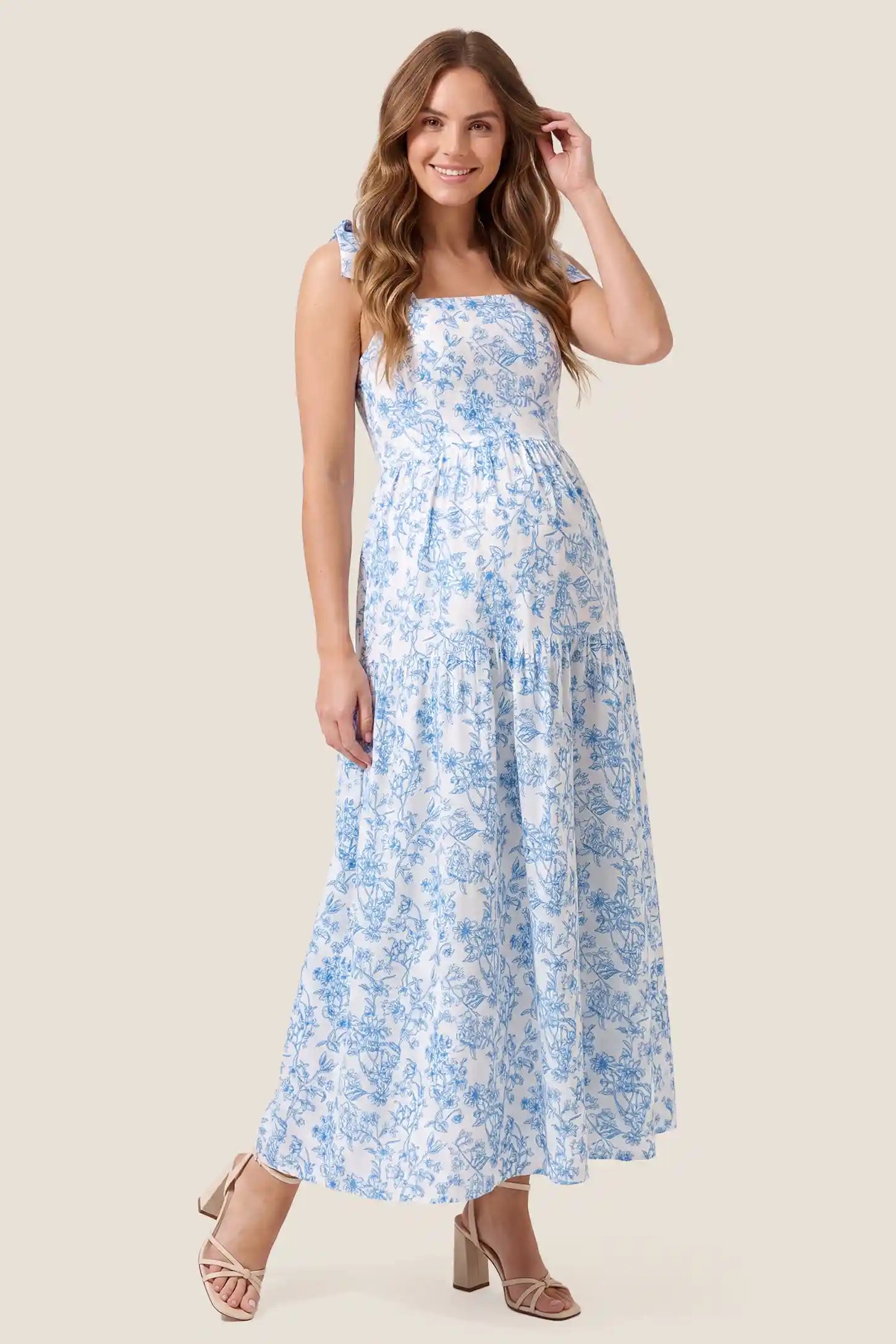 Floral Cami Tiered Maxi Maternity Dress Standard front view of the Floral Cami Tiered Maxi Maternity Dress on a pregnant model with a clean white background.
