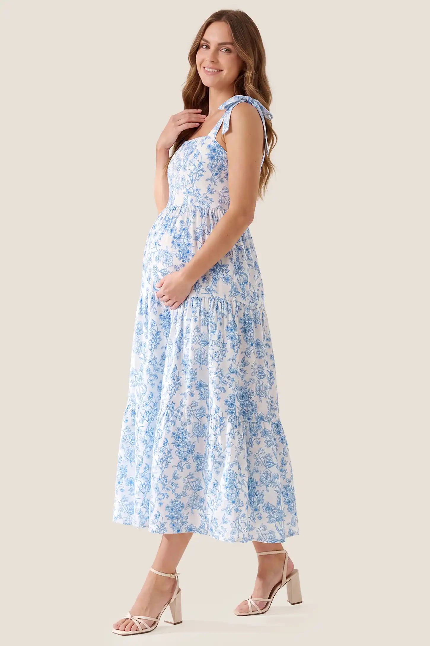 Floral Cami Tiered Maxi Maternity Dress Side view of the Floral Cami Tiered Maxi Maternity Dress, showing the fit over the growing bump.