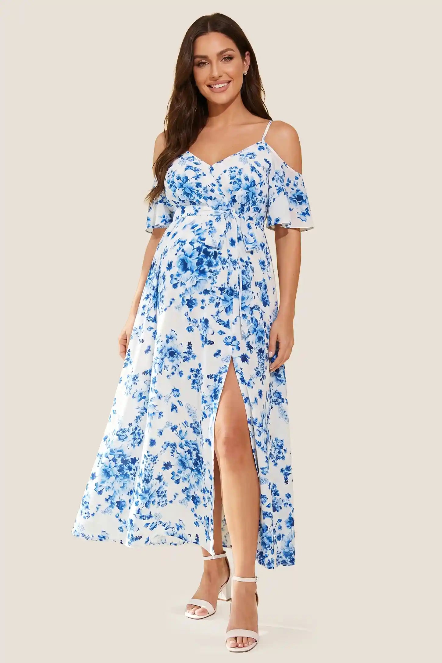 Elegant Floral Cold Shoulder Maternity Maxi Dress with Slit Standard front view of the blue and white floral cold shoulder maternity maxi dress with V-neckline and high slit on a pregnant model.