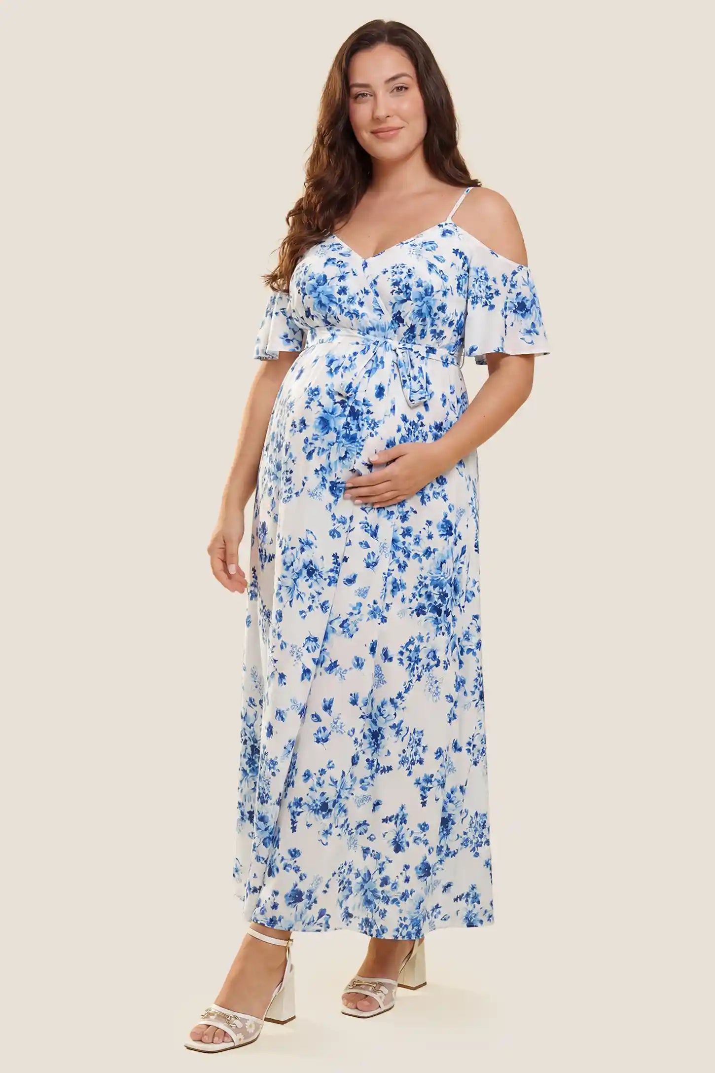 Elegant Floral Cold Shoulder Maternity Maxi Dress with Slit Front view of the blue and white floral cold shoulder maternity maxi dress on a plus-size pregnant model, emphasizing the comfortable fit.