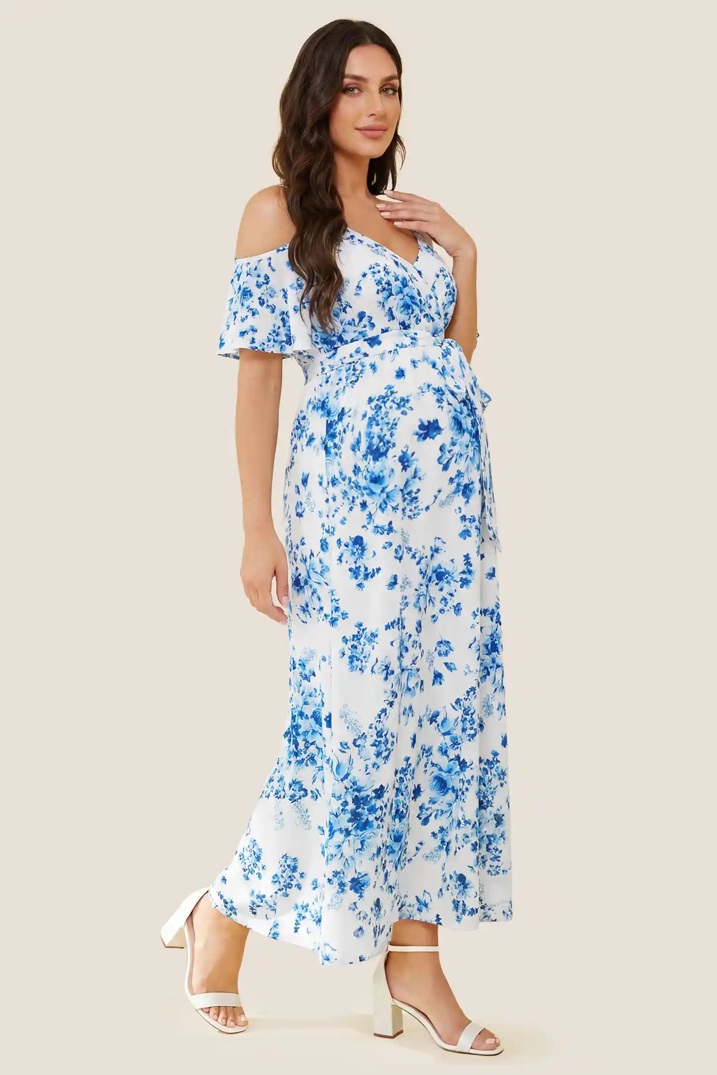 Elegant Floral Cold Shoulder Maternity Maxi Dress with Slit Side view of the blue and white floral cold shoulder maternity maxi dress, showing the fit over the growing bump.
