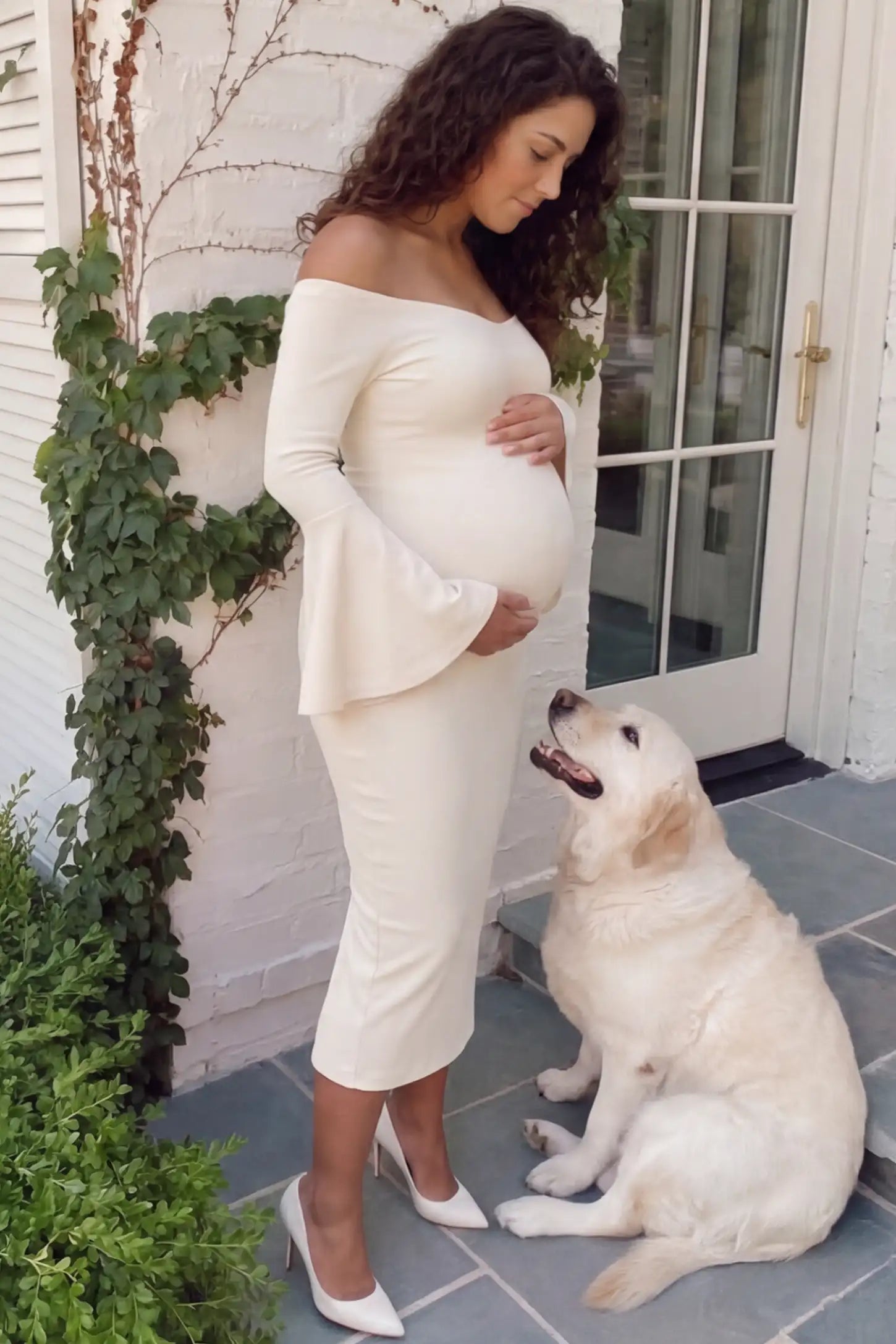 Boat Neck Bell Sleeve Maternity Midi Dress Boat Neck Bell Sleeve Maternity Midi Dress in beige featuring a high stretch fit on a pregnant woman at an outdoor setting side view.