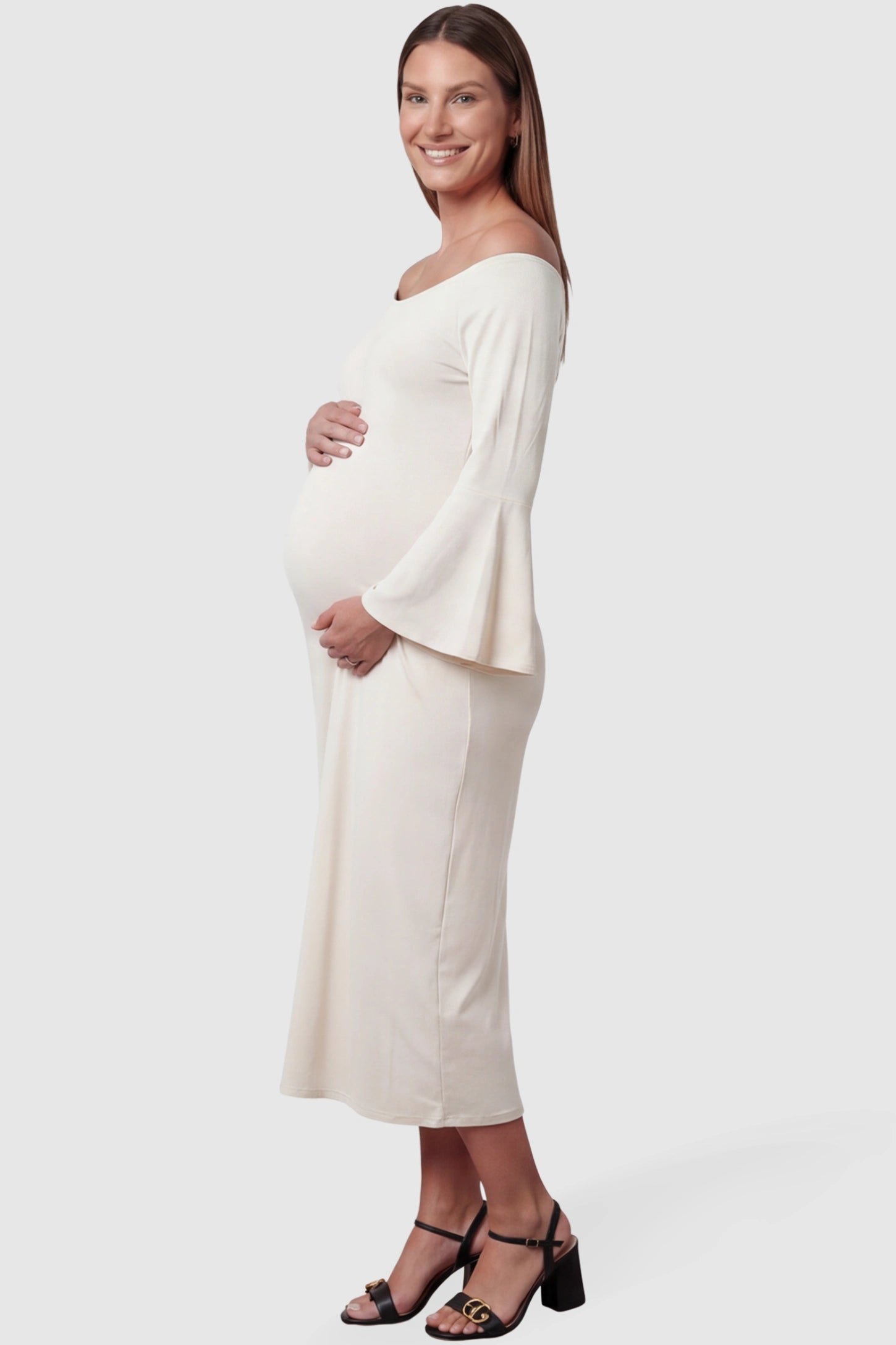 Boat Neck Bell Sleeve Maternity Midi Dress Boat Neck Bell Sleeve Maternity Midi Dress in beige featuring a high stretch fit on a pregnant model side view.