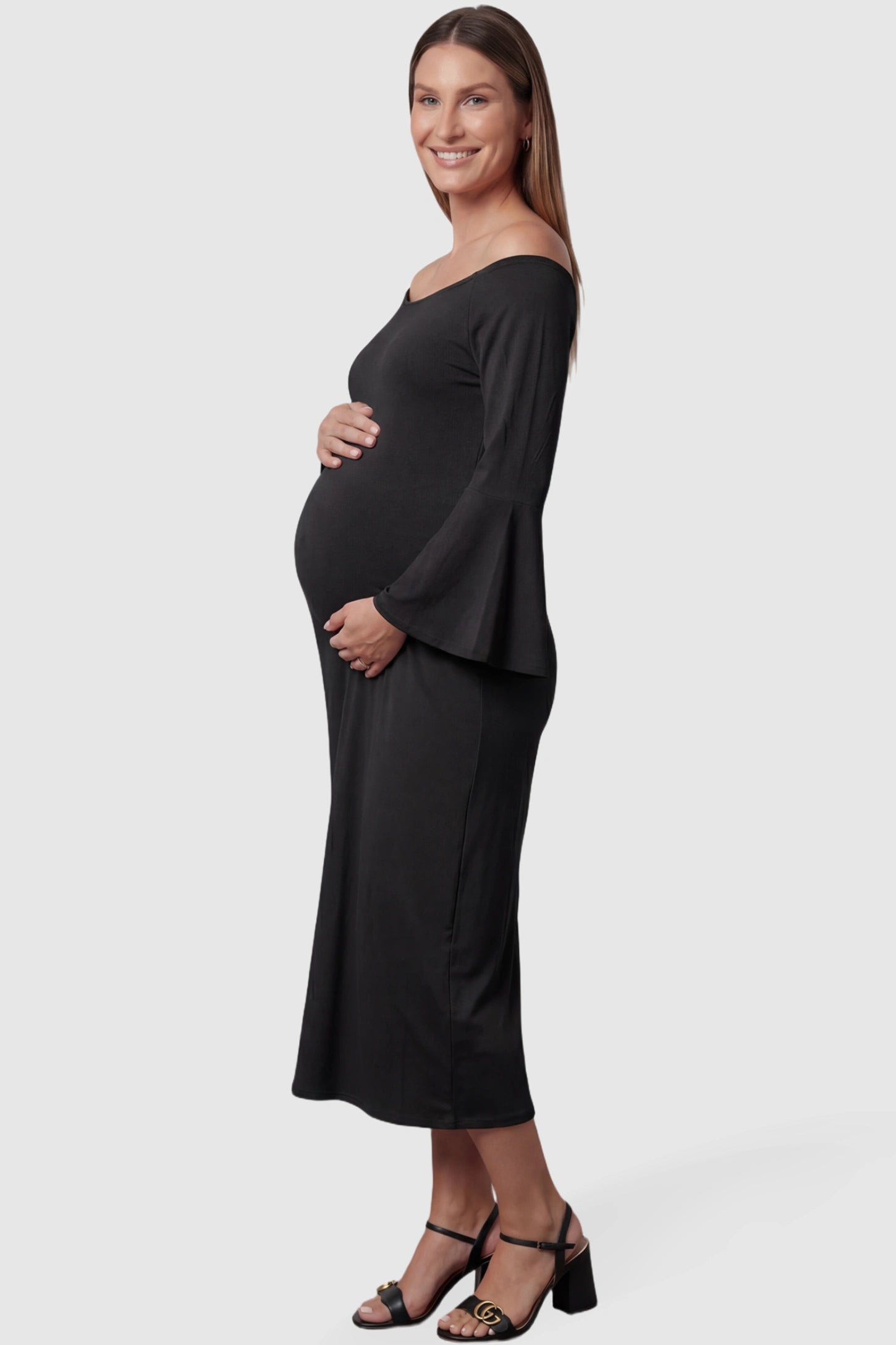 Boat Neck Bell Sleeve Maternity Midi Dress Boat Neck Bell Sleeve Maternity Midi Dress in Black featuring a high stretch fit on a pregnant model side view.