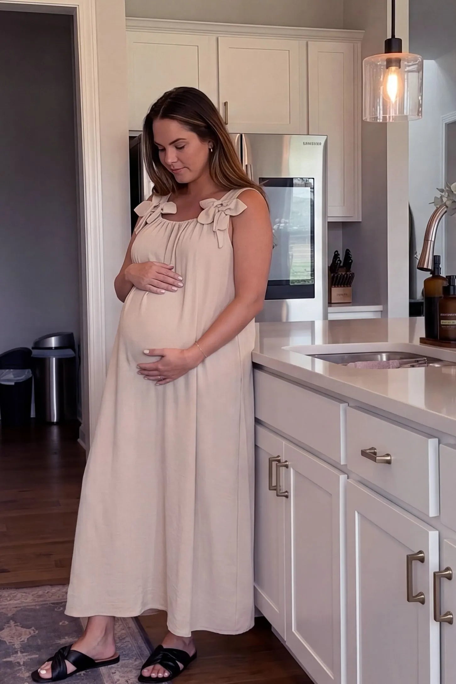 Bow Strap A-Line Maternity Dress Side profile of Cream Bow Strap A-Line Maternity Dress showing the airy cotton blend on a pregnant model.
