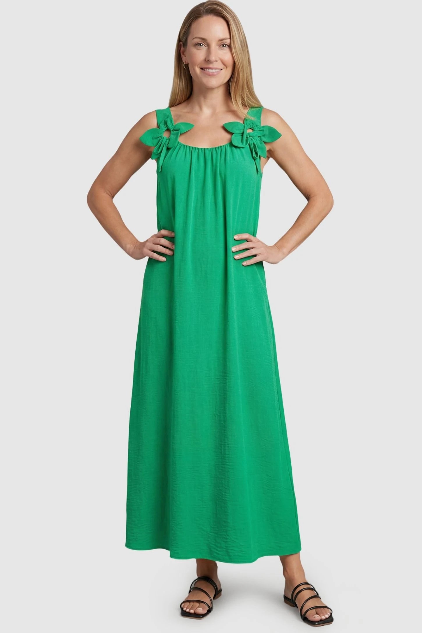 Bow Strap A-Line Maternity Dress Green Bow Strap A-Line Maternity Dress on a postpartum model featuring a flattering relaxed waistline.