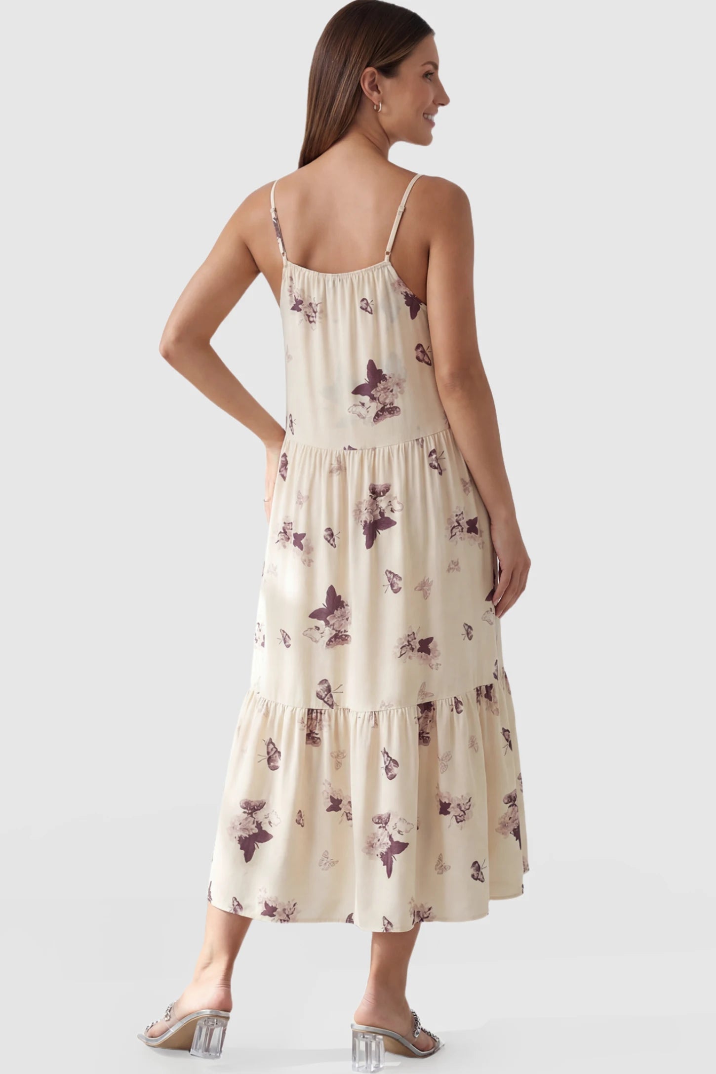 Butterfly Print V-Neck Tiered Maternity Midi Dress Butterfly Print Tiered Maternity Midi Dress in Beige Brown featuring a V-neckline and spaghetti straps on a pregnant model showing back.